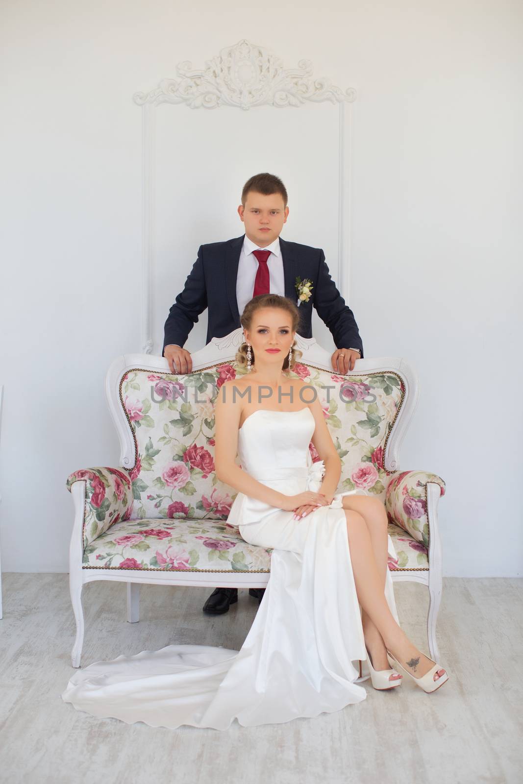 Stylish newlyweds posing for photography at the apartment