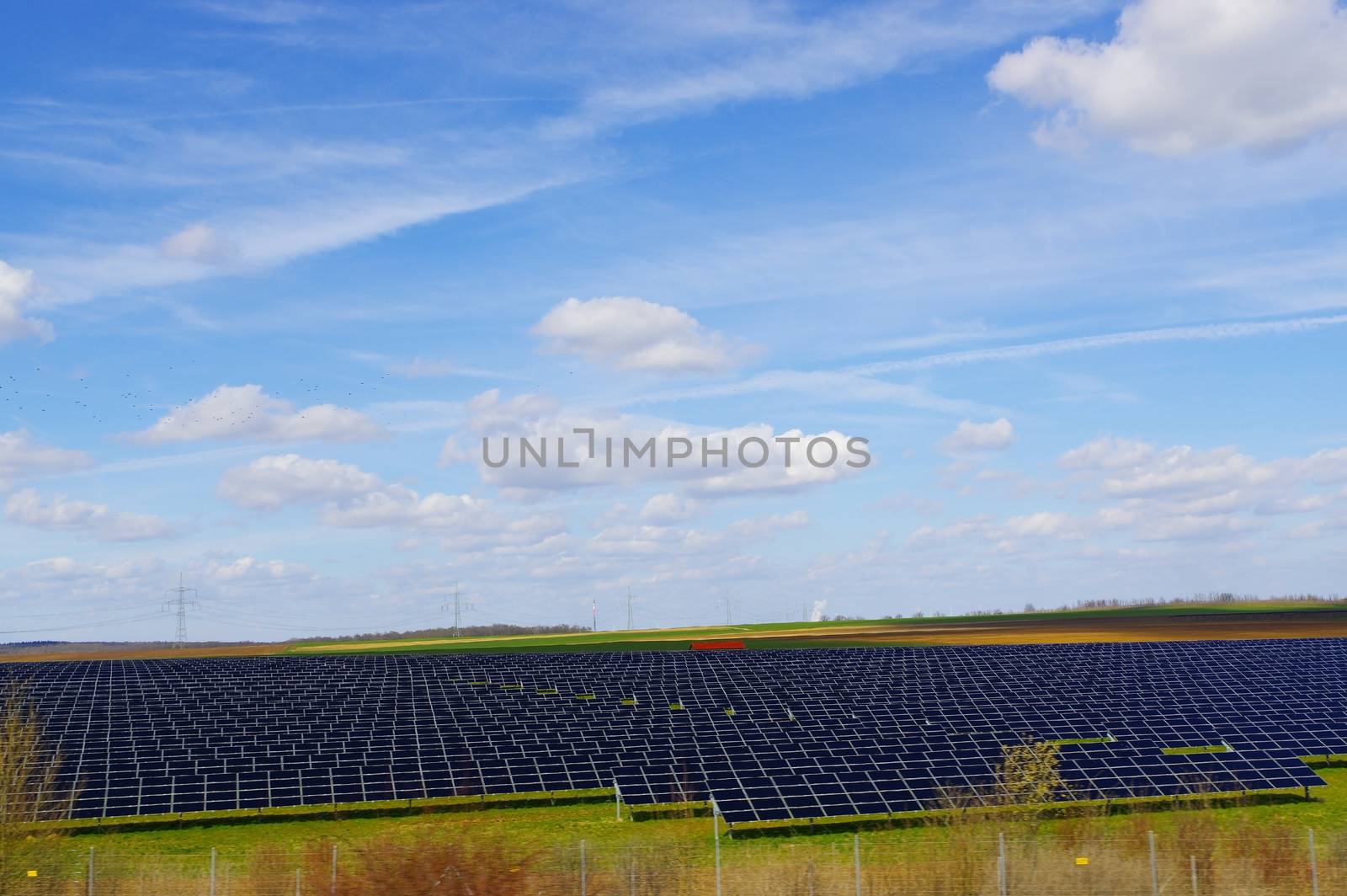 field and medow with solar panels on it by evolutionnow