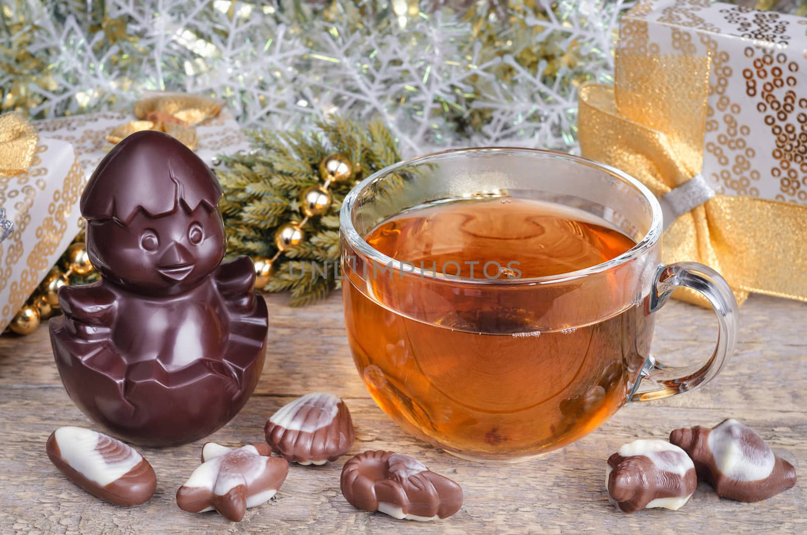 Christmas and a Cup of hot tea on old wooden background surface. Chocolate symbol of the year.