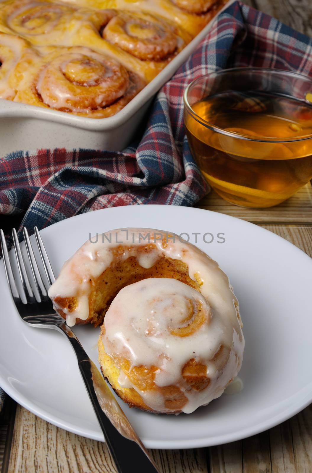 Broken bun of pumpkin with cinnamon in the form of snails closeup