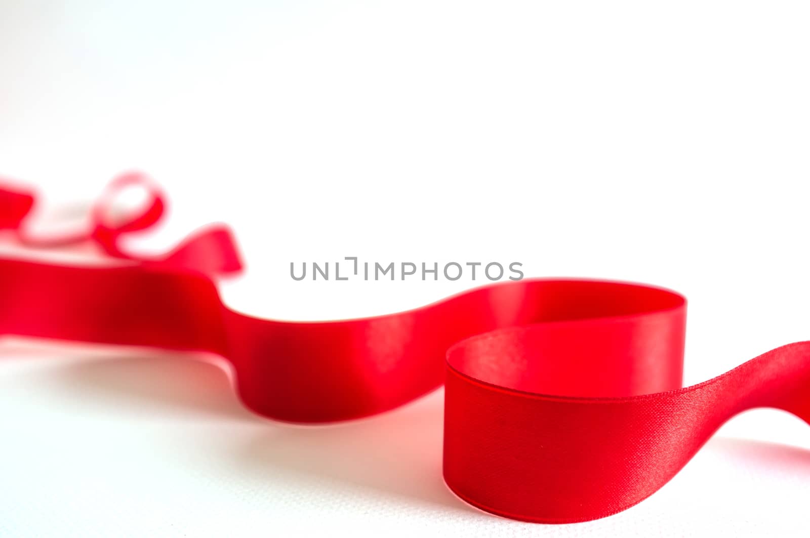 Red satin ribbon isolated on white background