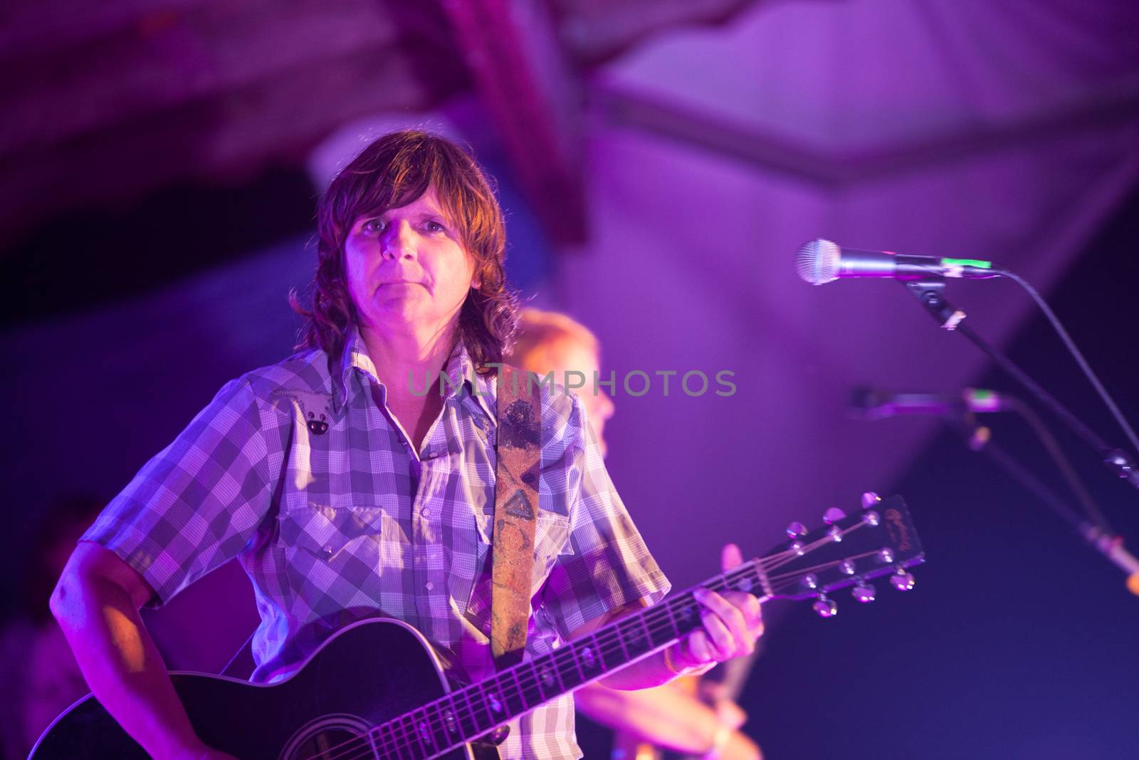 HOT SPRINGS, NC - AUGUST 10: The Indigo Girls partner Amy Ray plays guitar on stage at the Wild Goose Festival at night on August 10, 2013 in Hot Springs, NC, USA