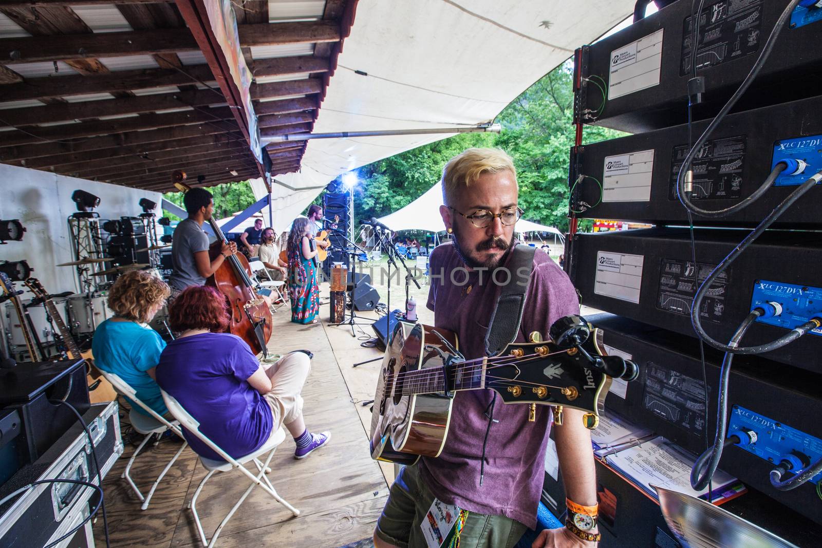 HOT SPRINGS, NC - JULY 9: Guitarist and song writer Matt Morris leans on an amplifier while waiting to perform at the Wild Goose Festival on July 9, 2016 in Hot Springs, NC, USA.