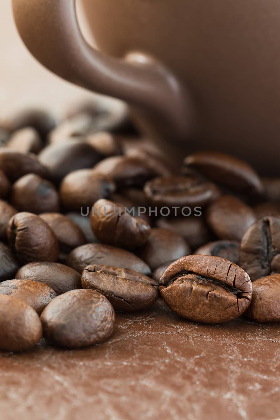 Close up roasted coffee beans and coffee cup