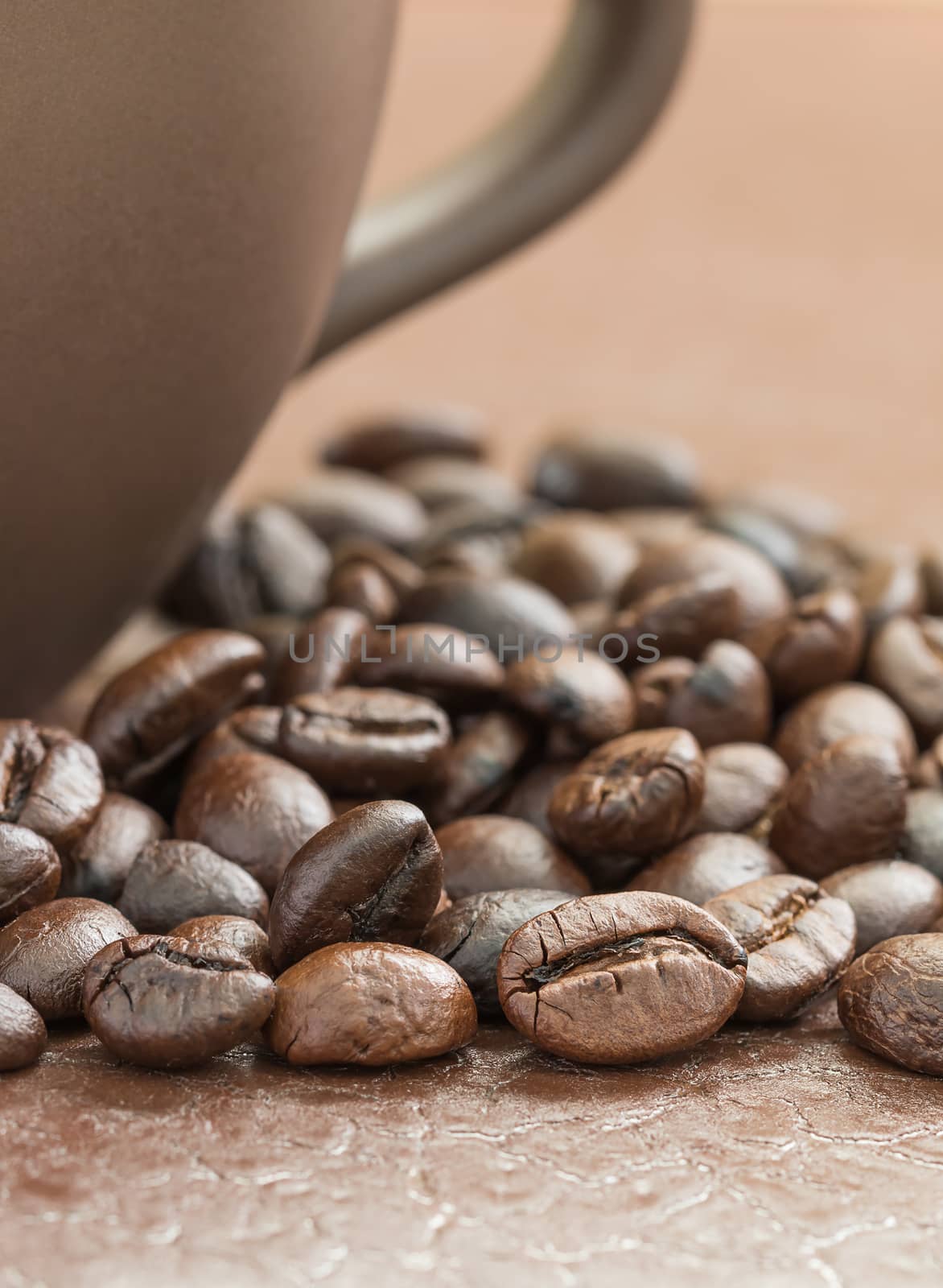 Close up roasted coffee beans and coffee cup