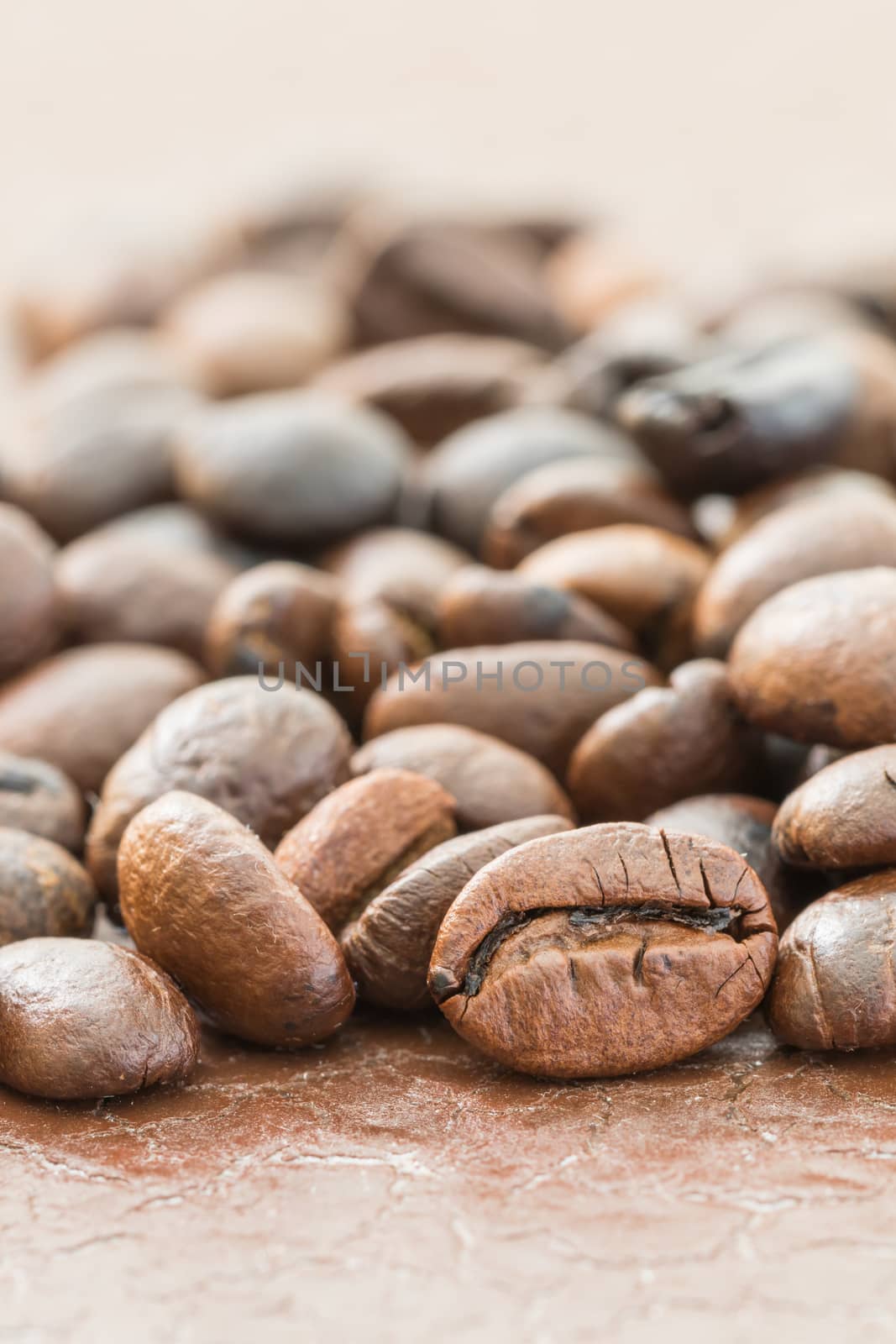 Close up heap of roasted brown coffee beans