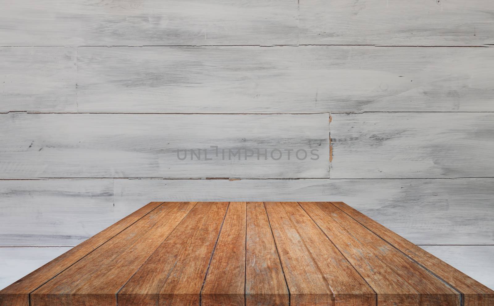 Perspective brown table top with white wooden wall background by punsayaporn