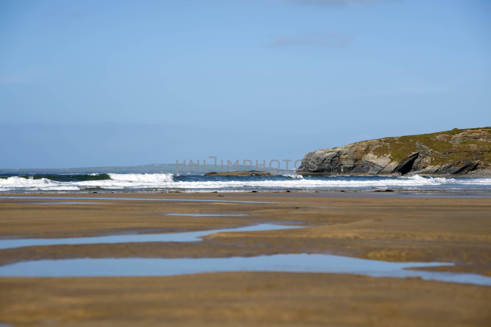 bright winter view of ballybunion beach and cliffs by morrbyte