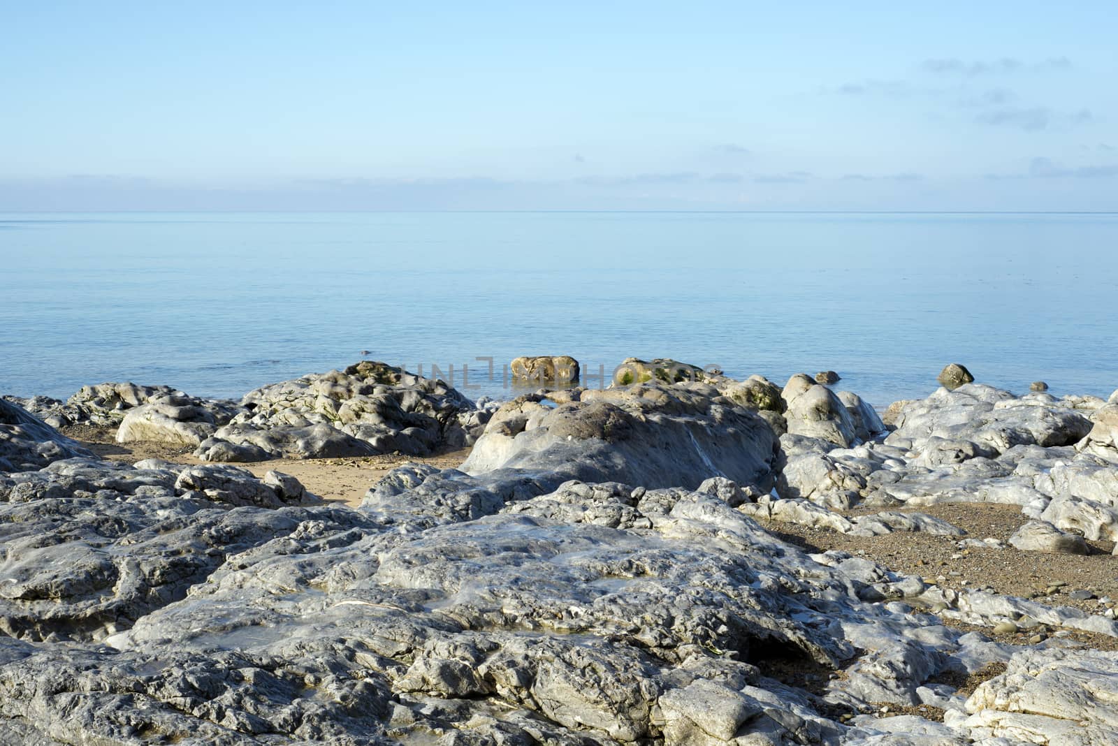 beautiful soft waves break on the rocks at ballybunion beach in ireland