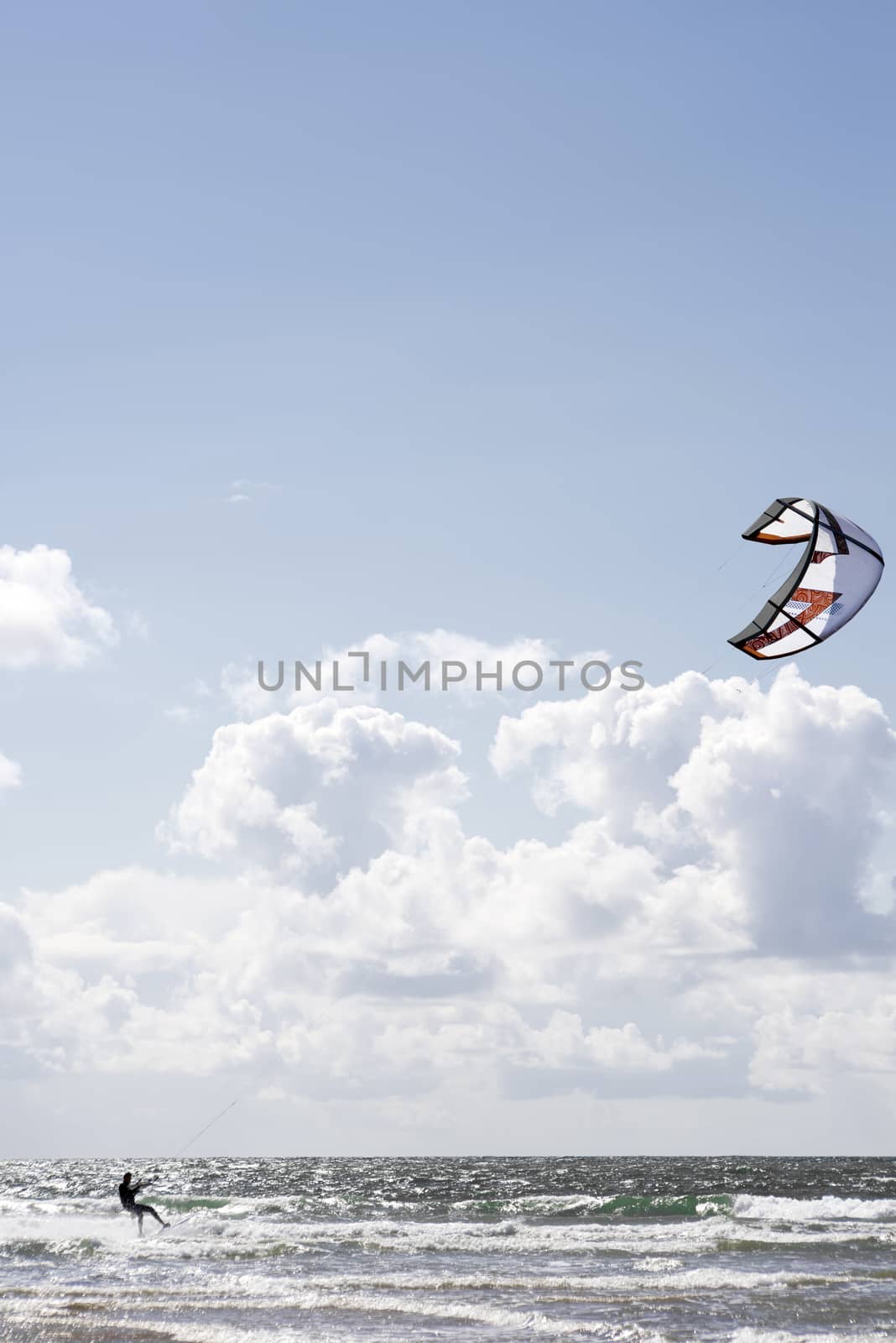 extreme kite surfer on beautiful waves by morrbyte