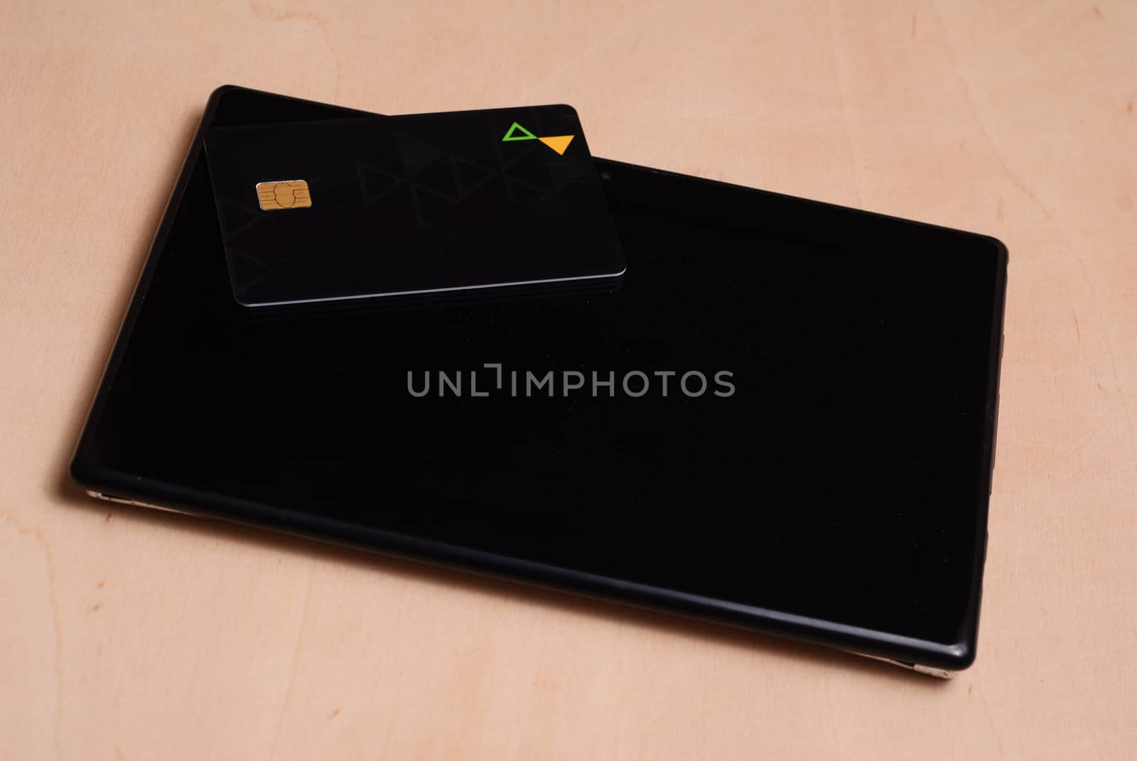 Black credit card is on a black electronic tablet, shopping online, mockup