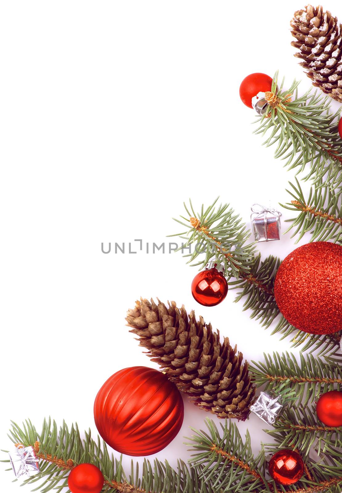 Arrangement of Christmas Decoration Theme with Spruce Branch, Fir Cones, Red Baubles and Silver Gift Boxes closeup on White background