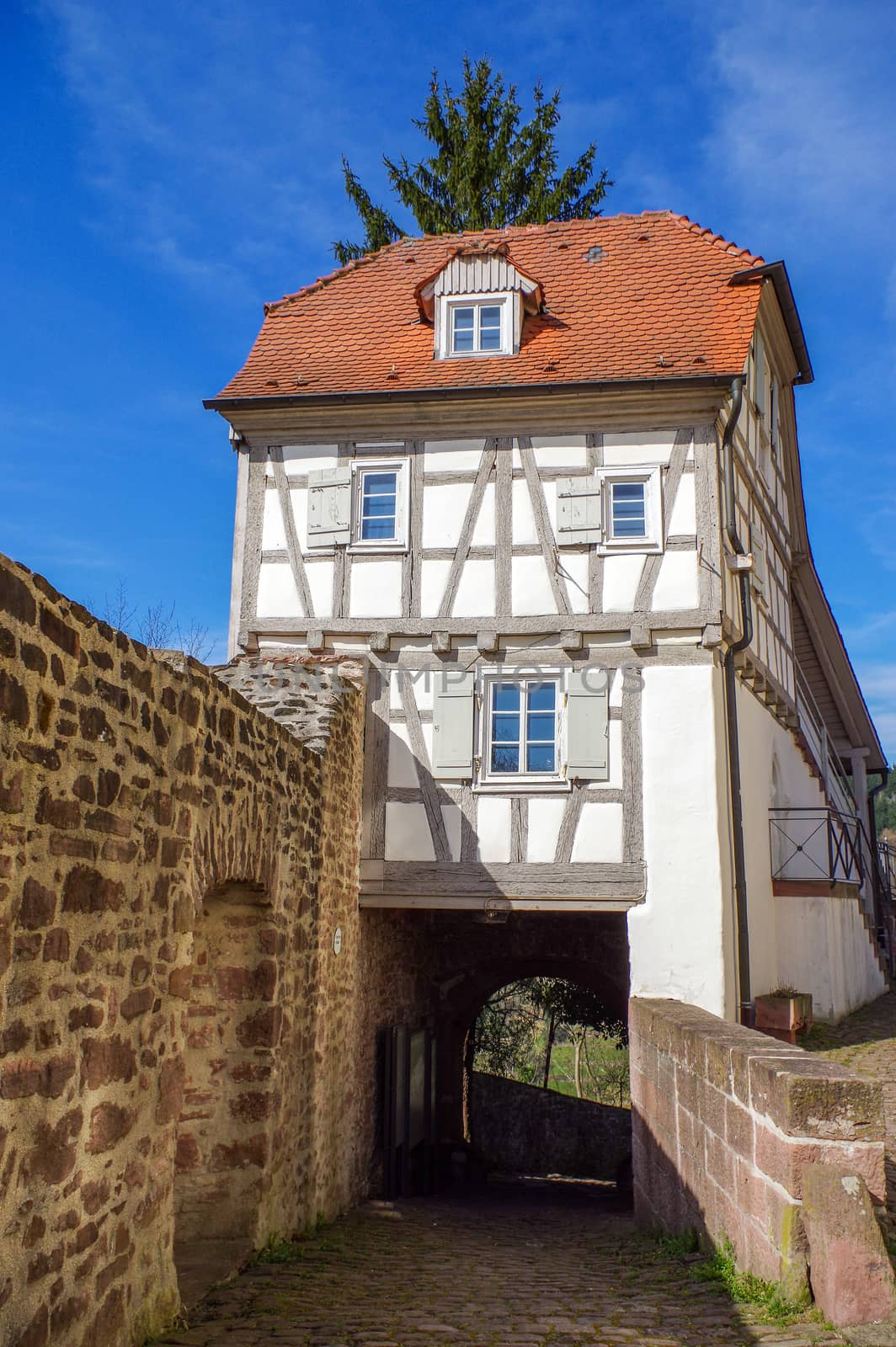 Residential tudor style house with blue sky in background by evolutionnow