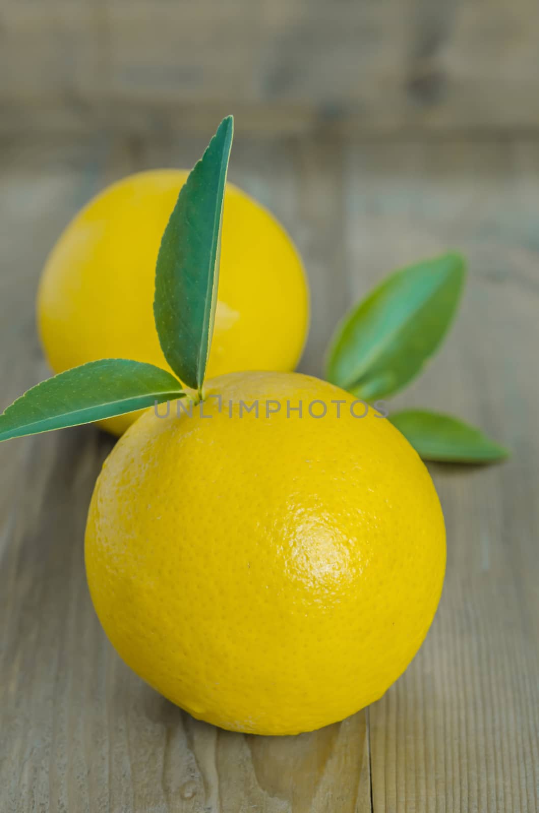 ripe orange with leaves on wooden background