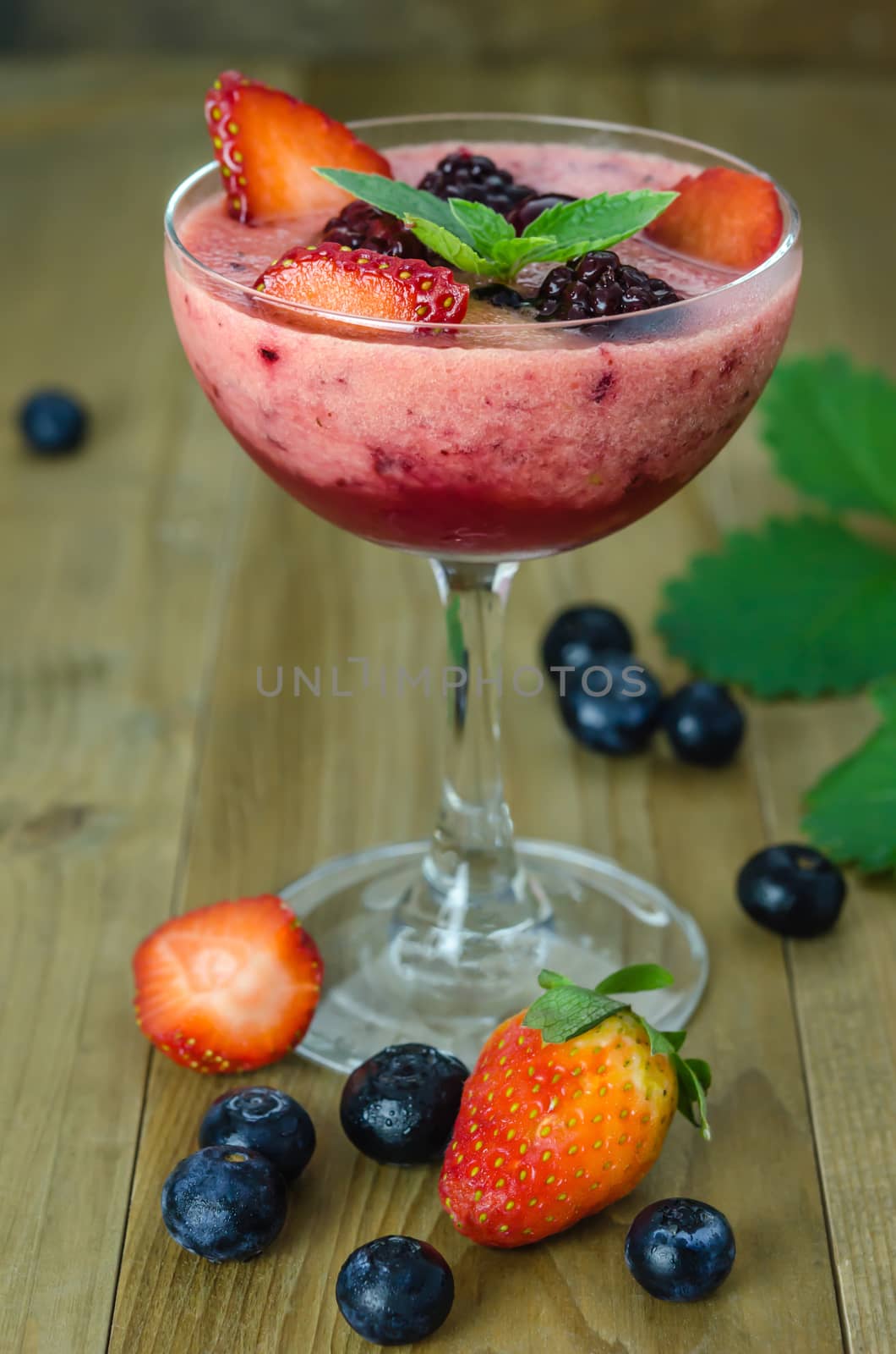 Raspberry smoothie with fresh berries on a wooden table