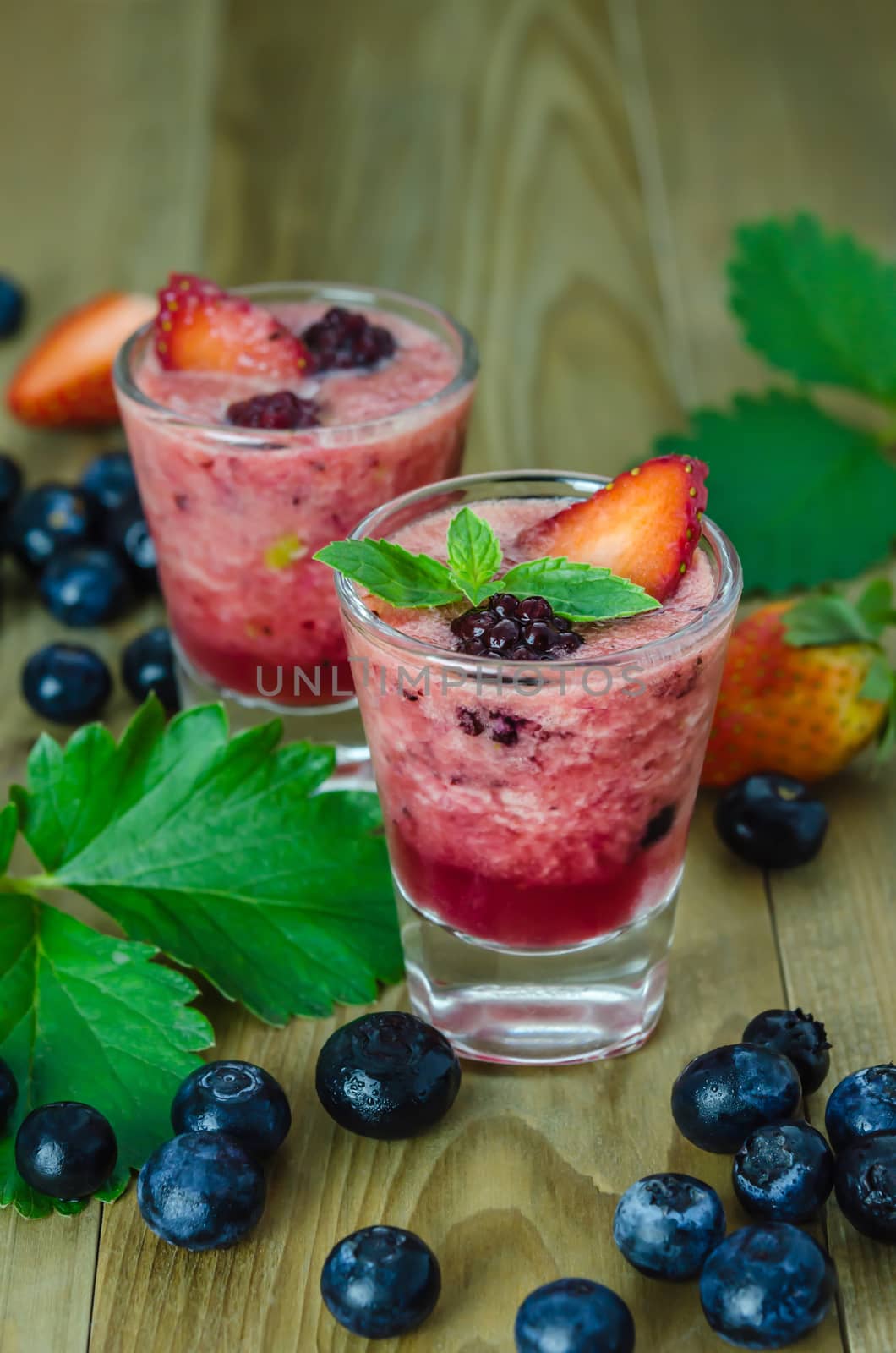 Raspberry smoothie with fresh berries on a wooden table by rakratchada