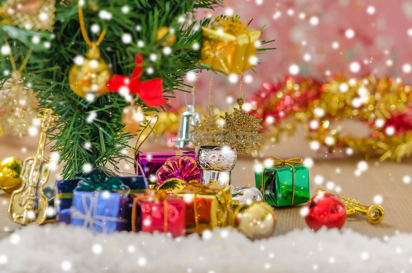 Christmas background with decorations and gift boxes on wooden board