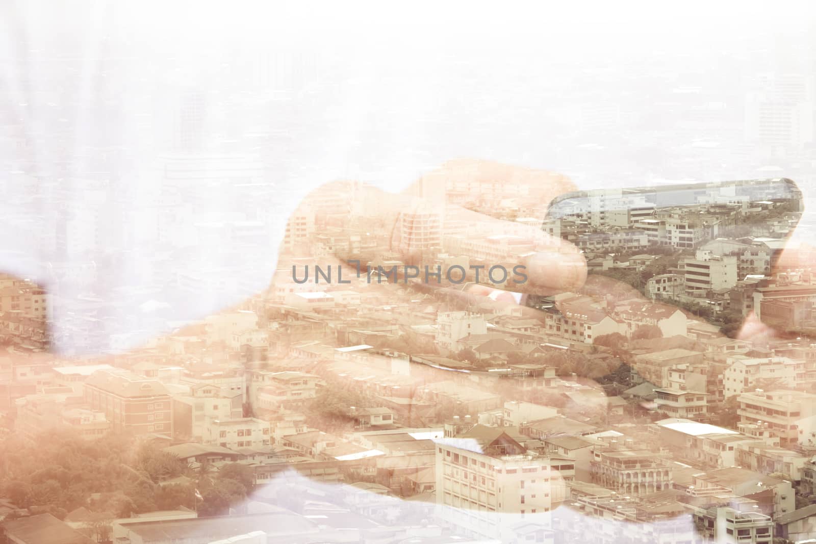 Double exposure of man using smart phone and cityscape background ,Business technology concept.