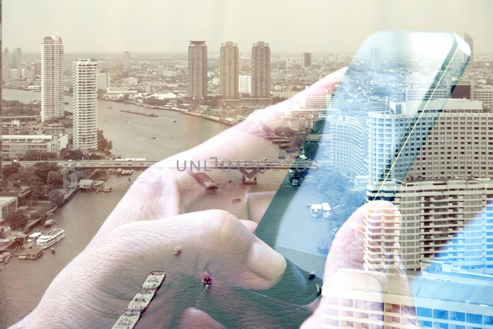 Double exposure of man using smart phone and cityscape background ,Business technology concept.