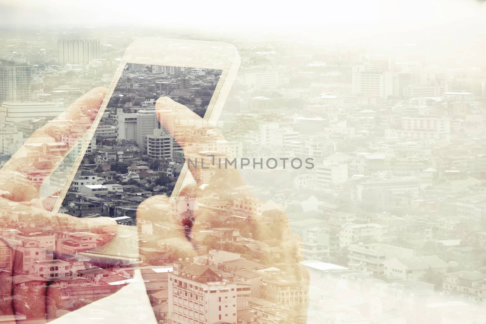 Double exposure of man using smart phone and cityscape background ,Business technology concept.