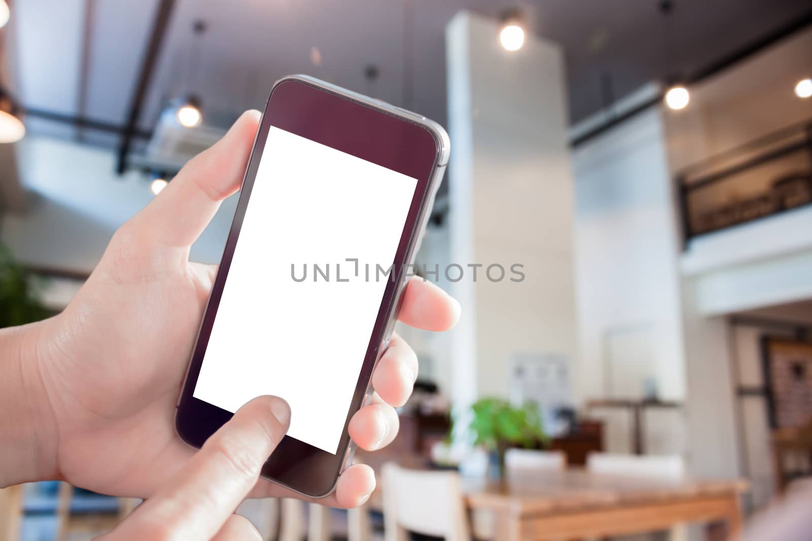 Woman using smartphone with abstract blur coffee shop, stock photo