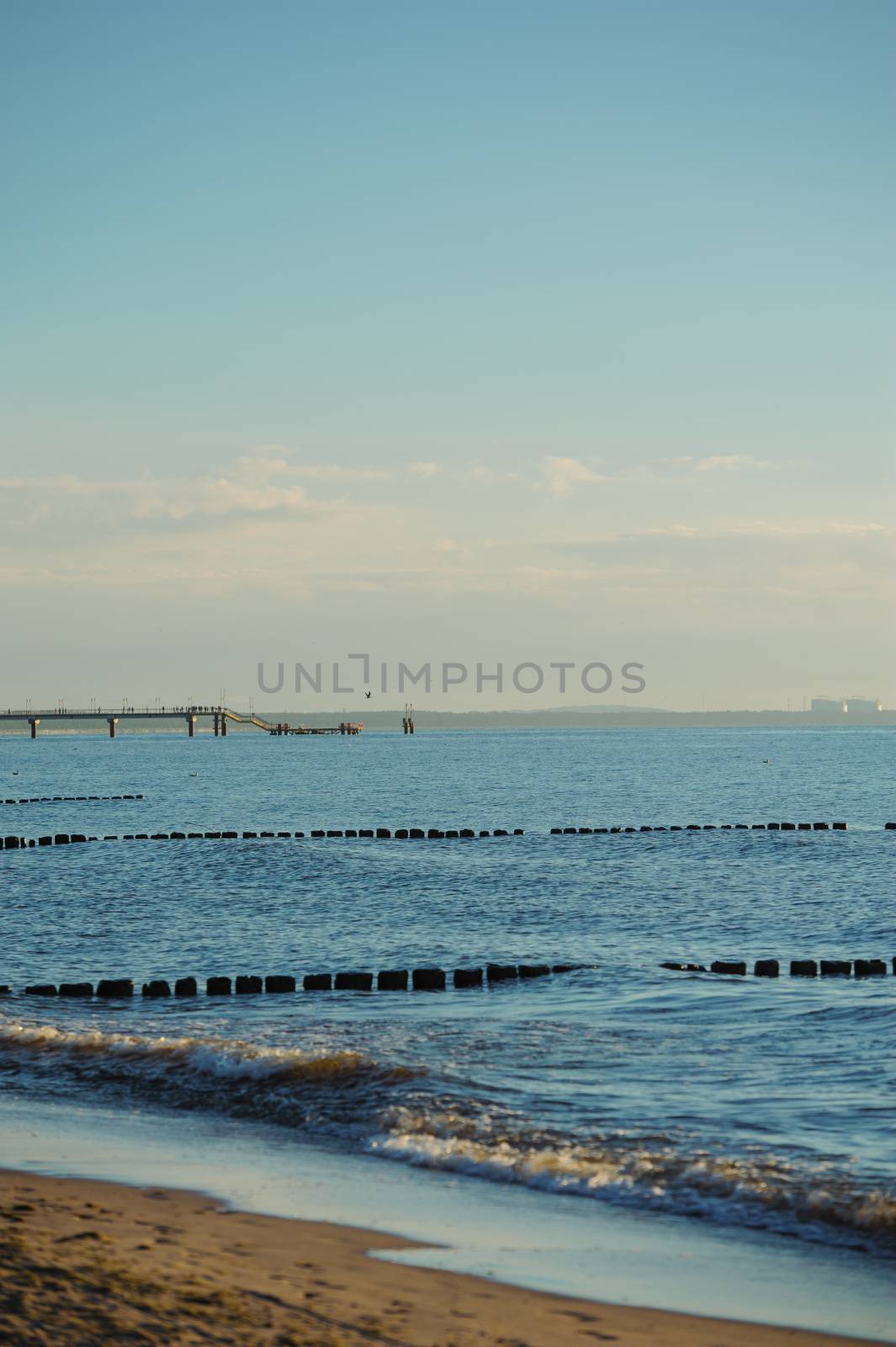 Breakwaters in the Baltic sea over the sunset in summer