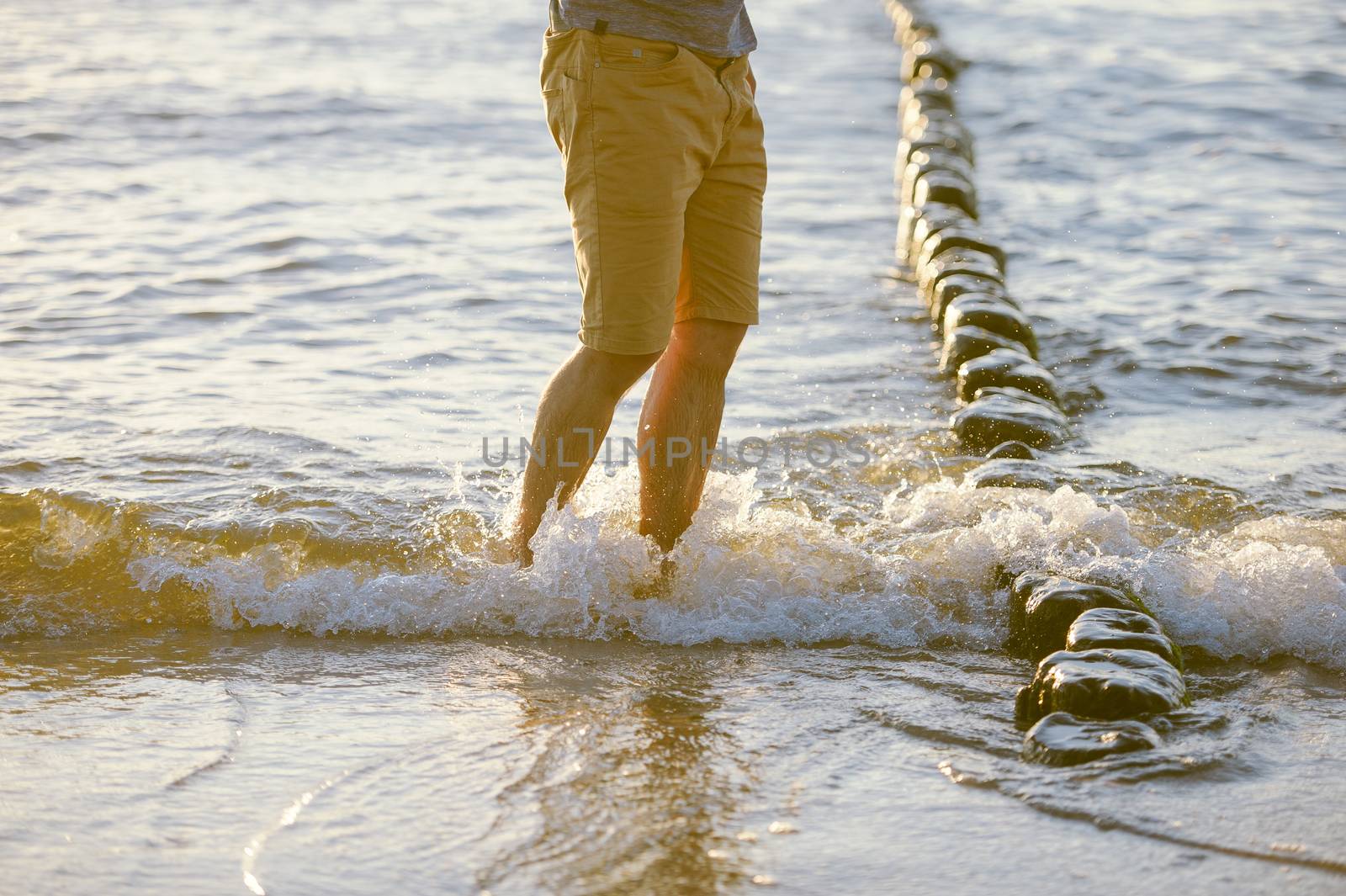 People walking on the beach in the ocean. Summer time