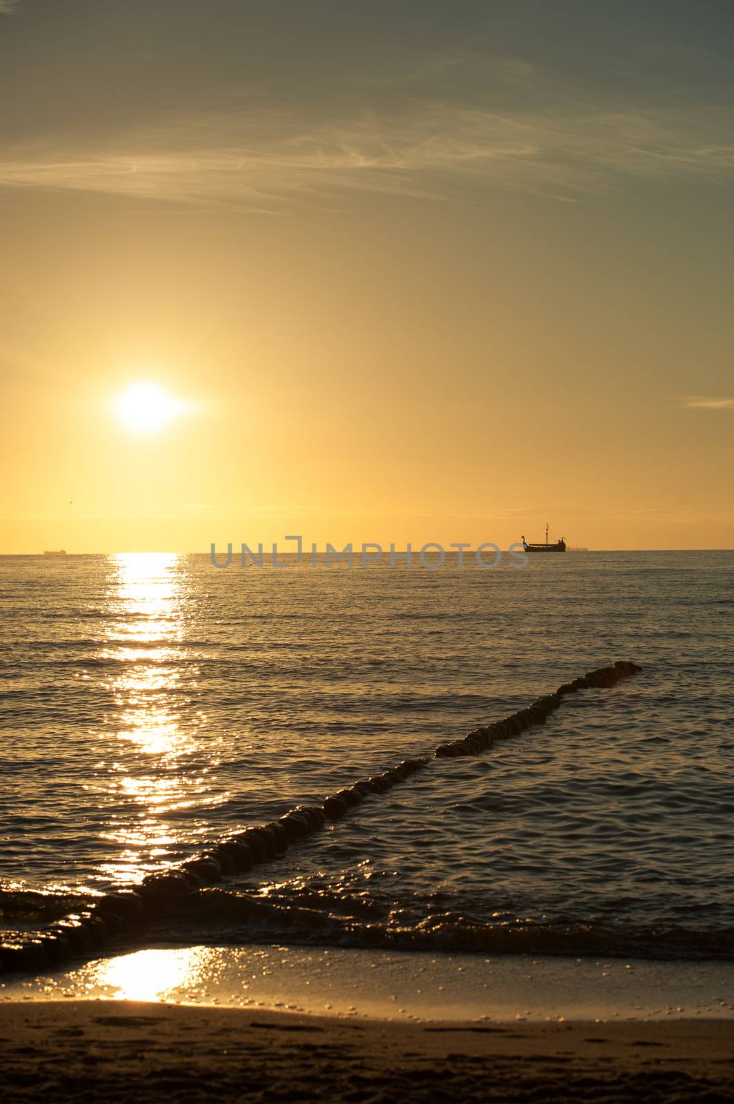 Breakwaters in the Baltic sea over the sunset in summer