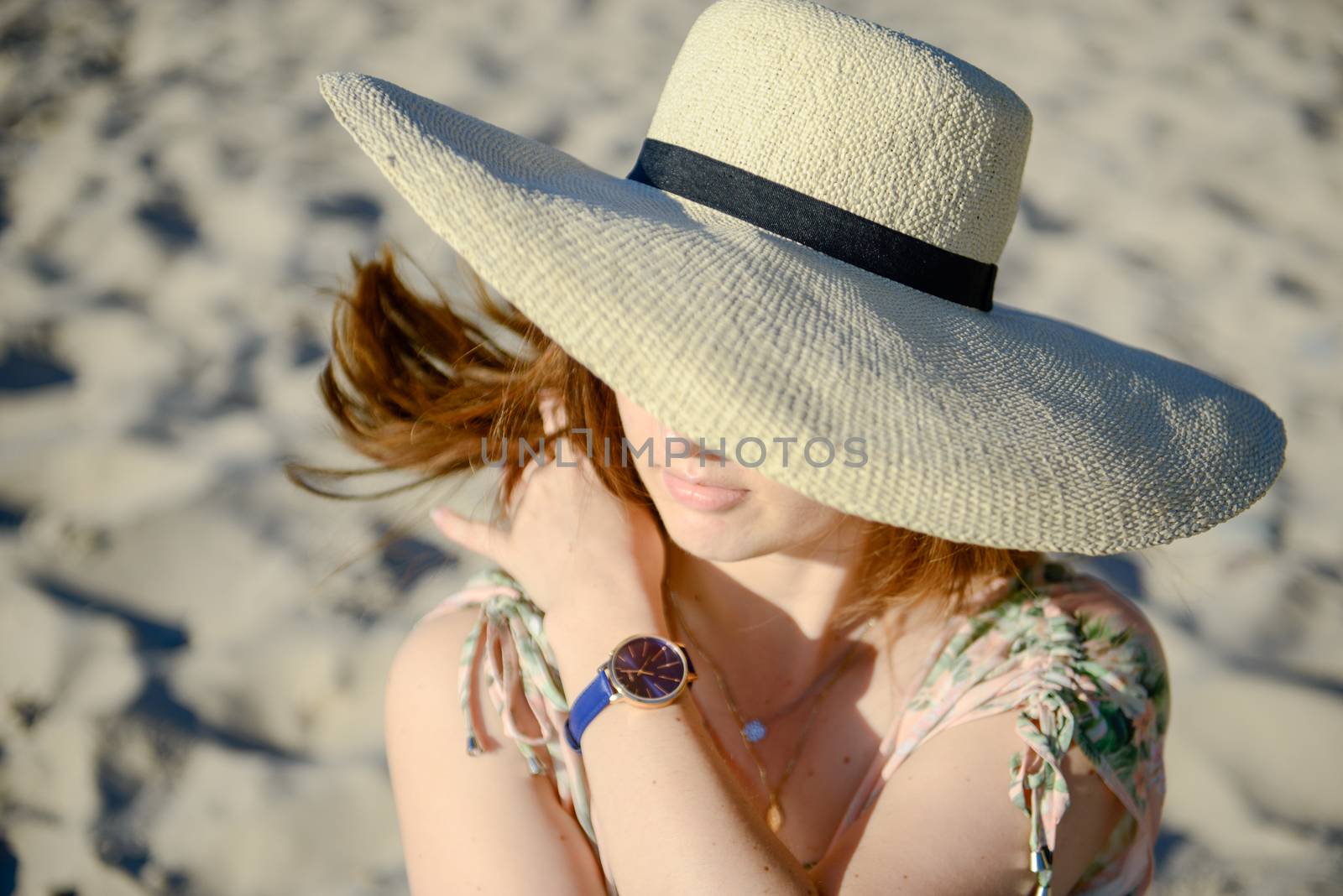 Young happy woman wearing dress on the beach. Summer time