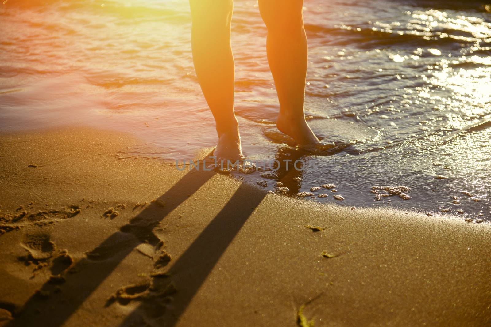 Vacation holidays. Feet closeup on beach on sunbed enjoying sun on sunny summer day.