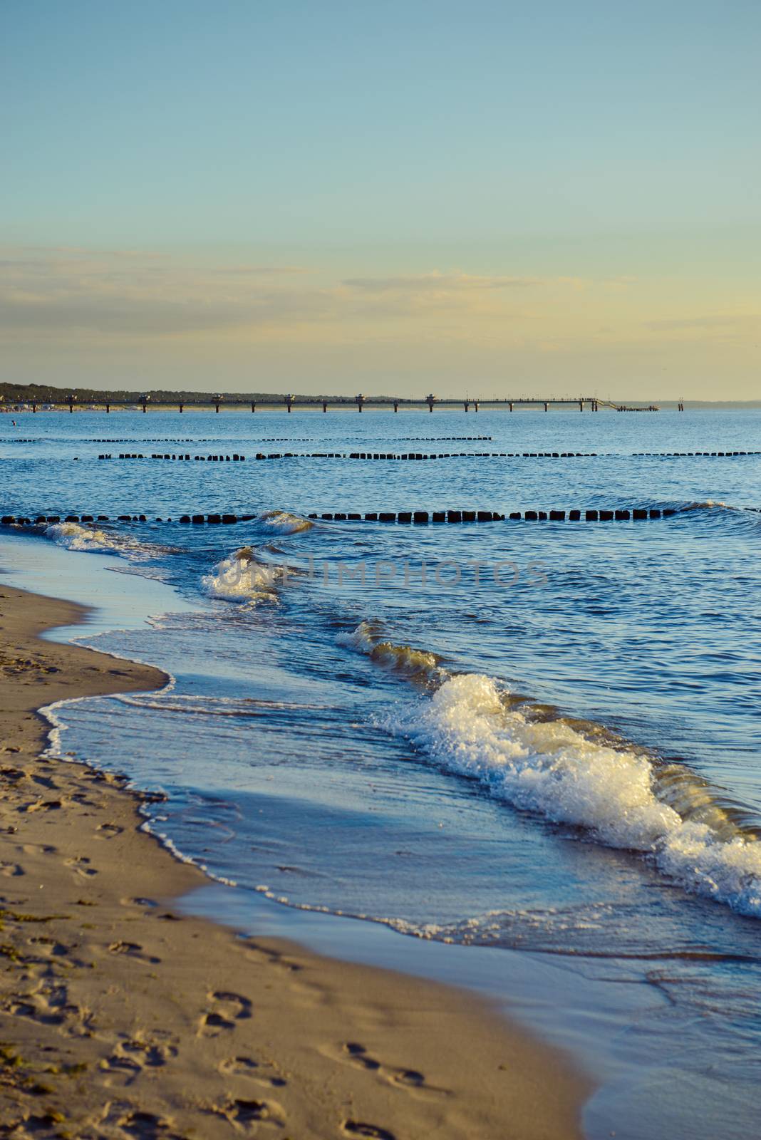 Breakwaters in the Baltic sea over the sunset in summer