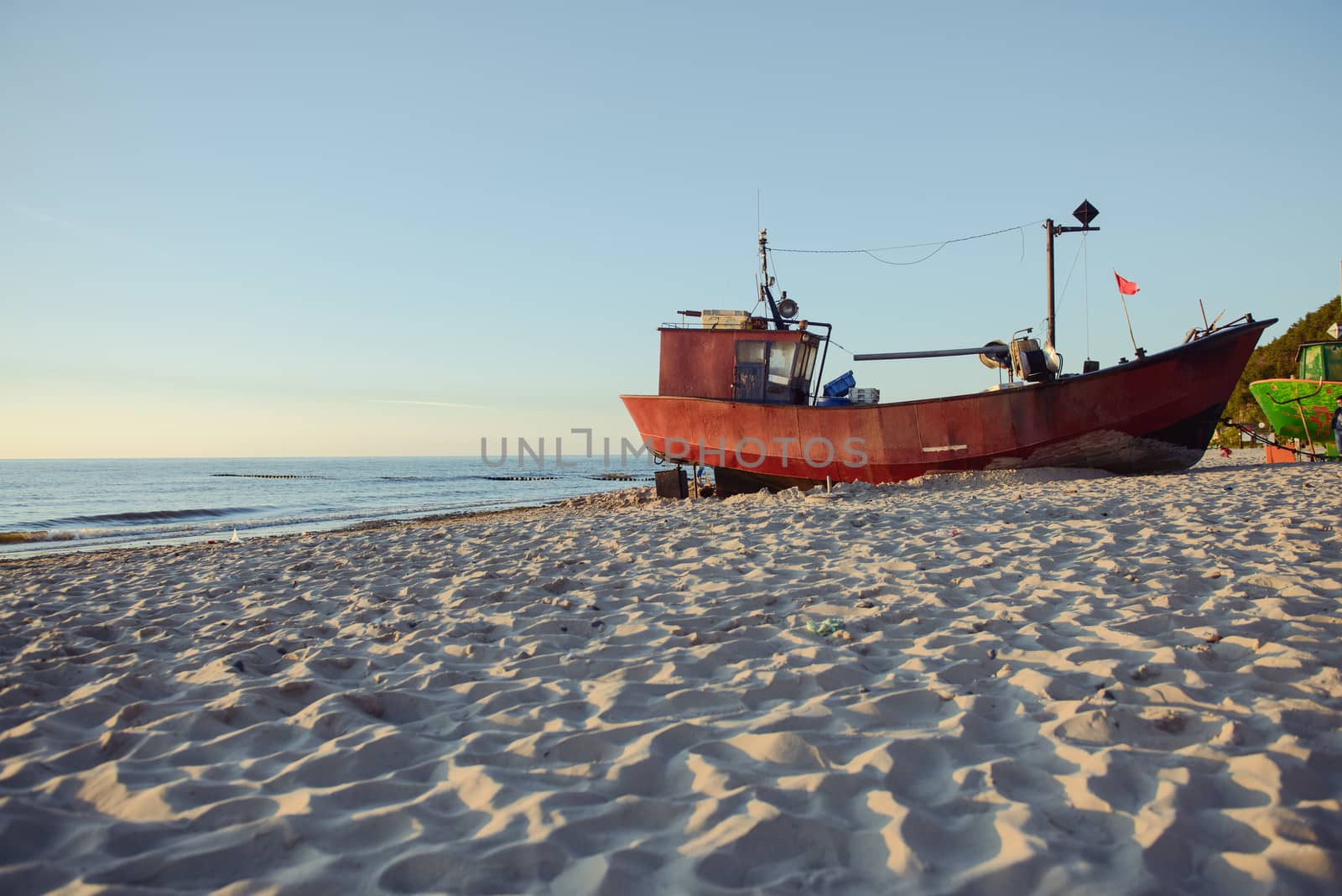 fisherman boats at sunrise time on the beach in summer