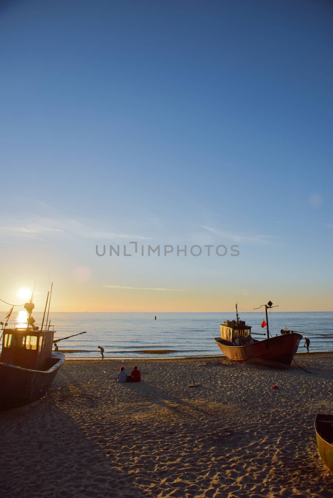 fisherman boats at sunrise time on the beach in summer