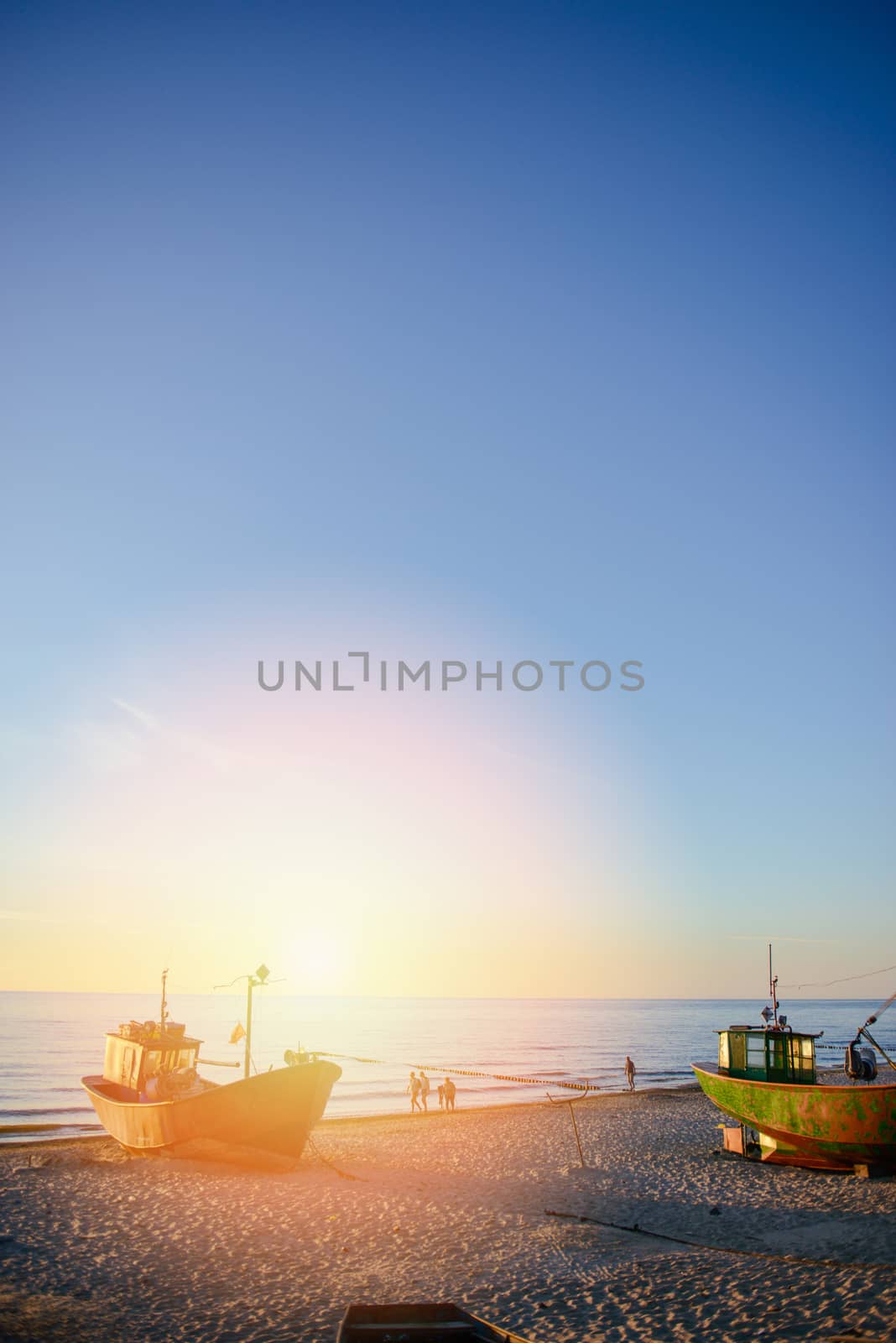 fisherman boats at sunrise time on the beach in summer
