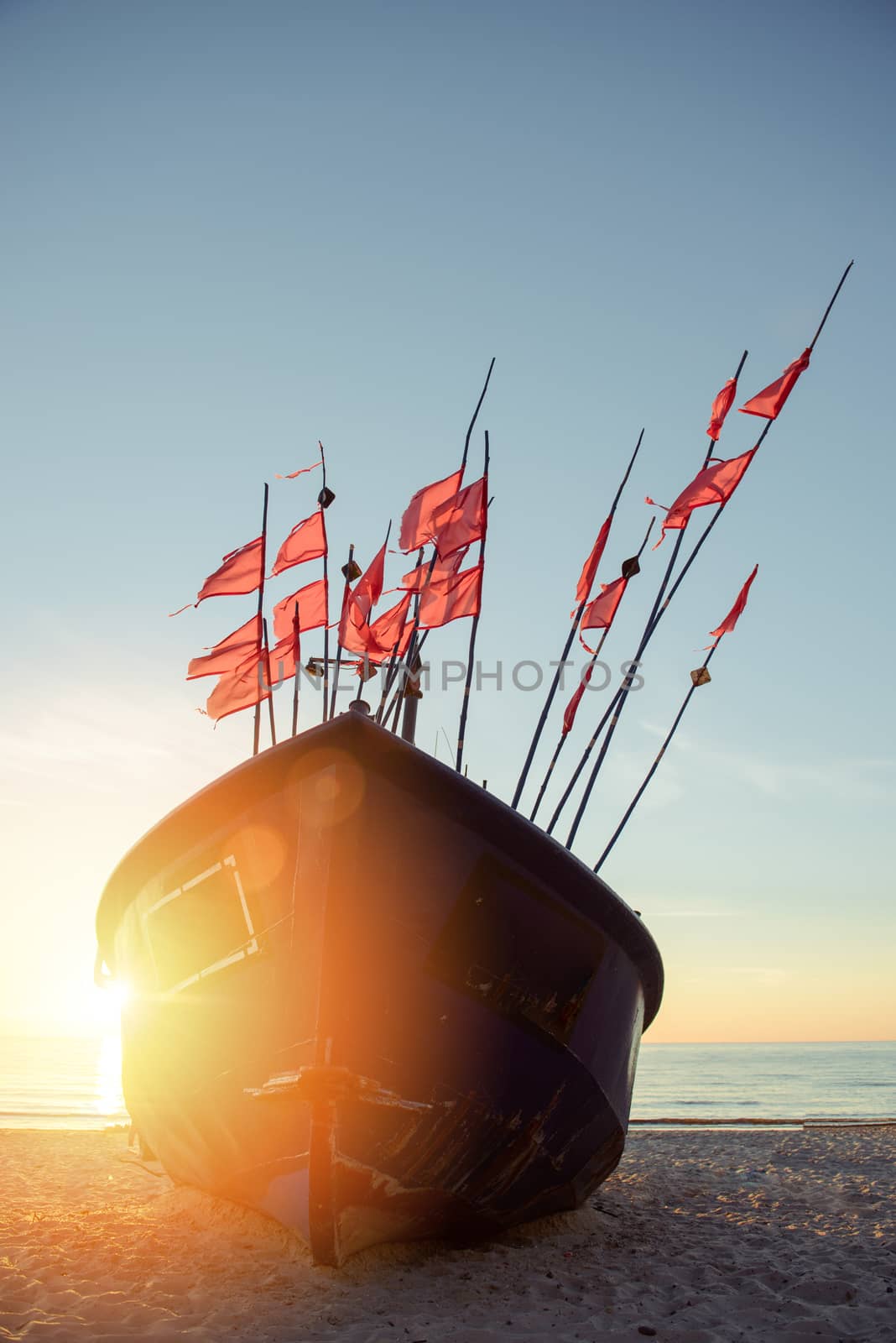 fisherman boats at sunrise time on the beach in summer