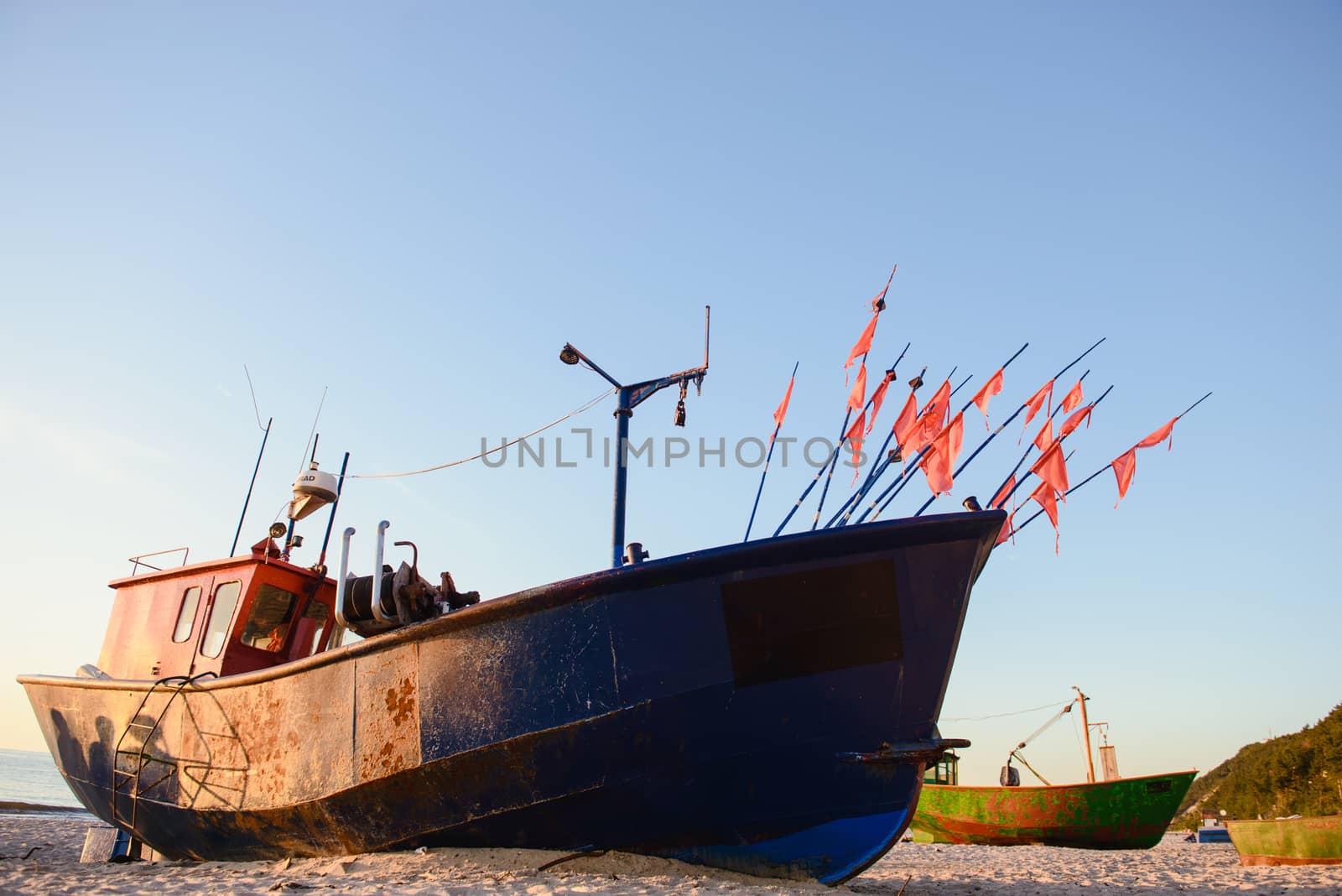 fisherman boats at sunrise time on the beach in summer