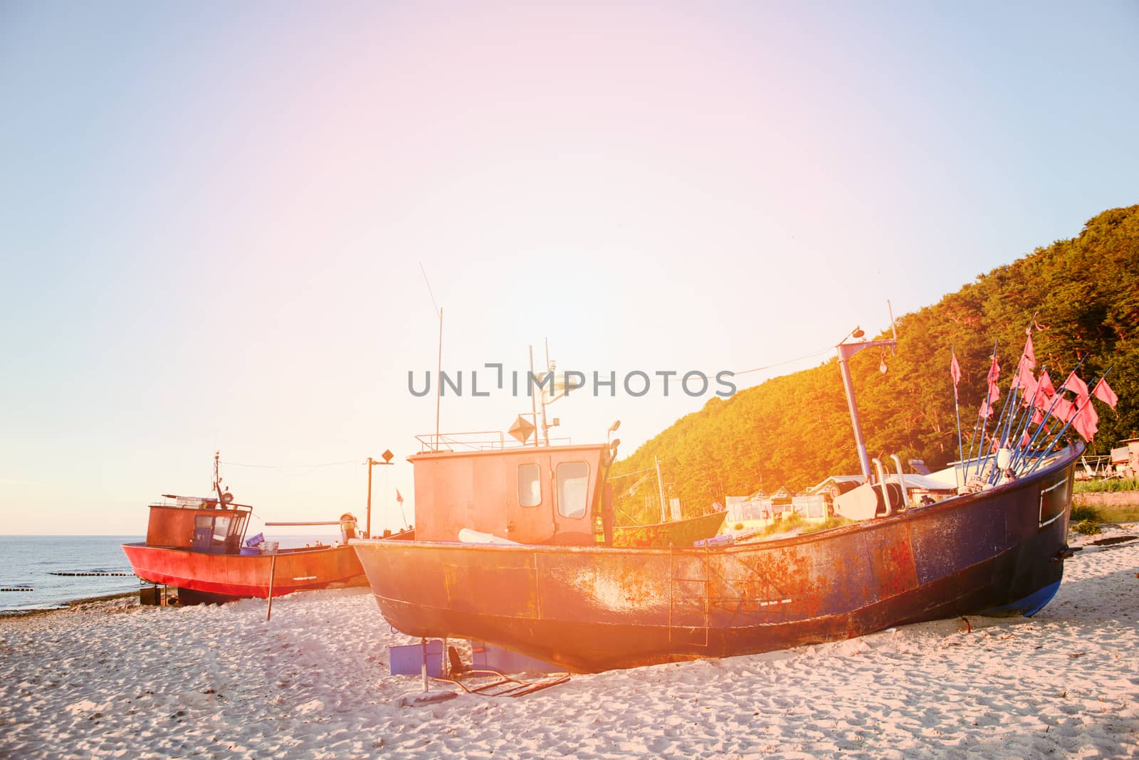 fisherman boats at sunrise time on the beach in summer