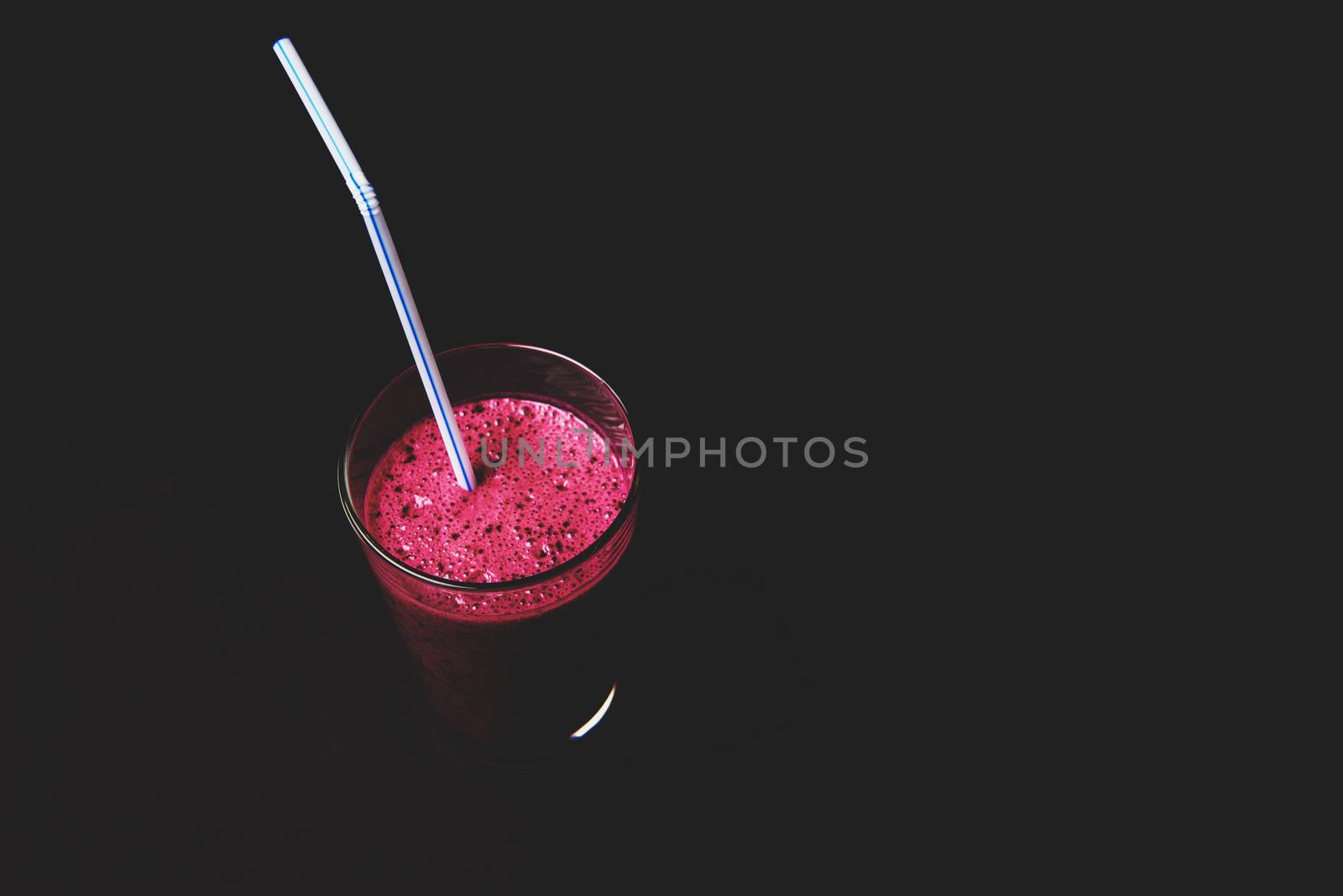 Blueberry smoothie with fresh berries, chia seeds and banana for breakfast on dark background, selective focus