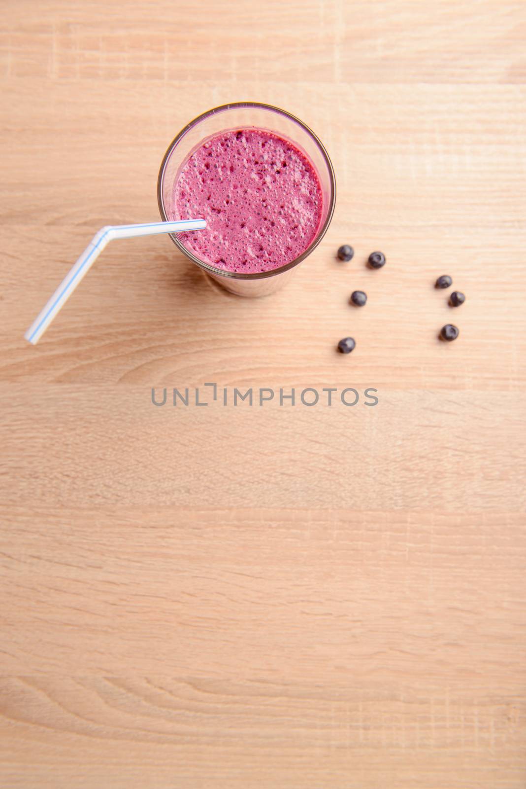 Blueberry smoothie with fresh berries, chia seeds and banana for breakfast on rustic wooden background, selective focus