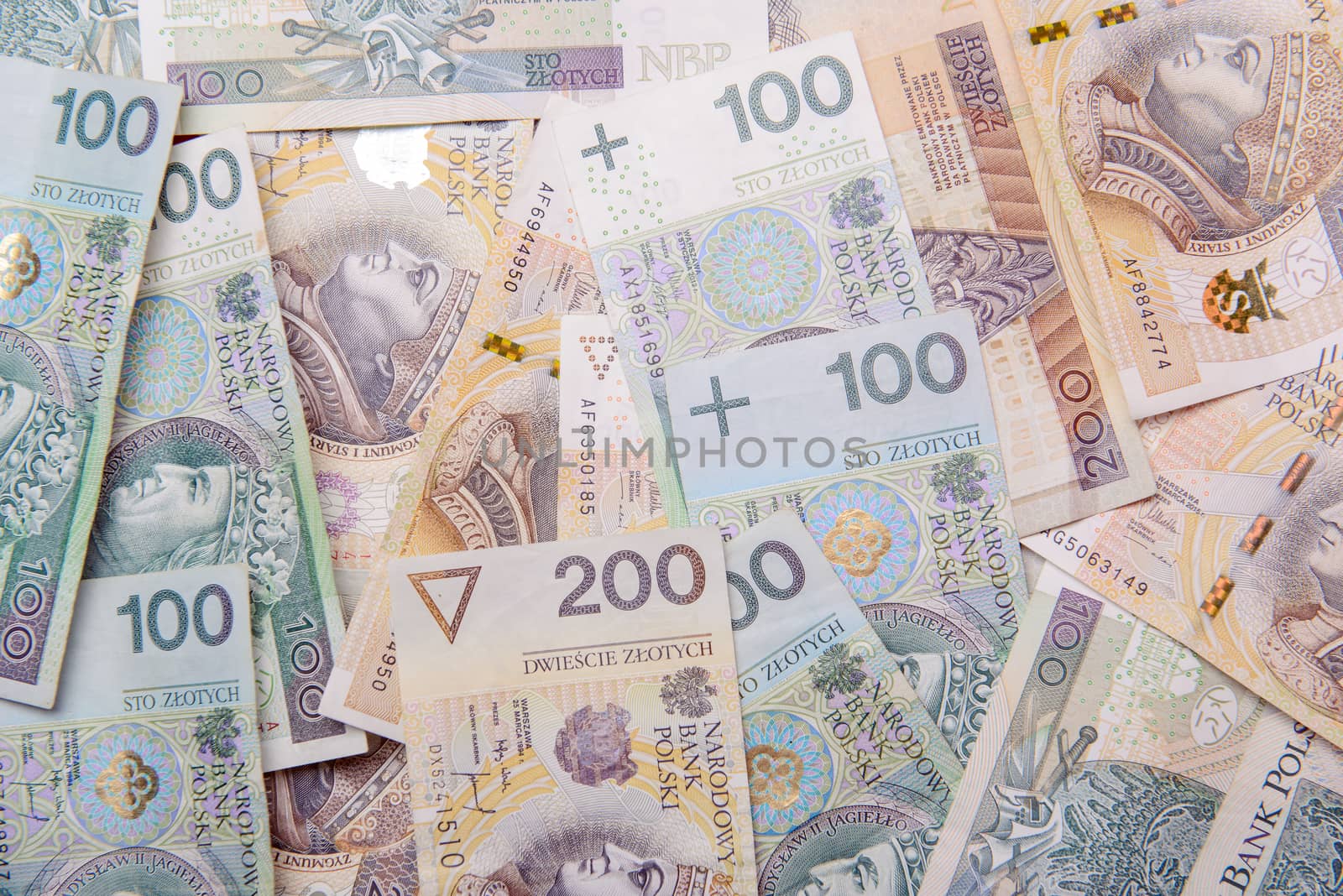 Polish zloty in notes and coins on red background