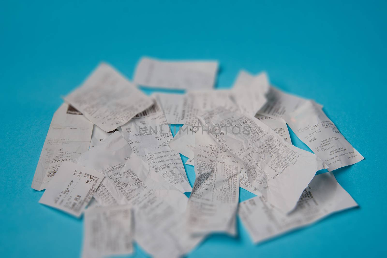 Pile of shopping receipts on a blue background
