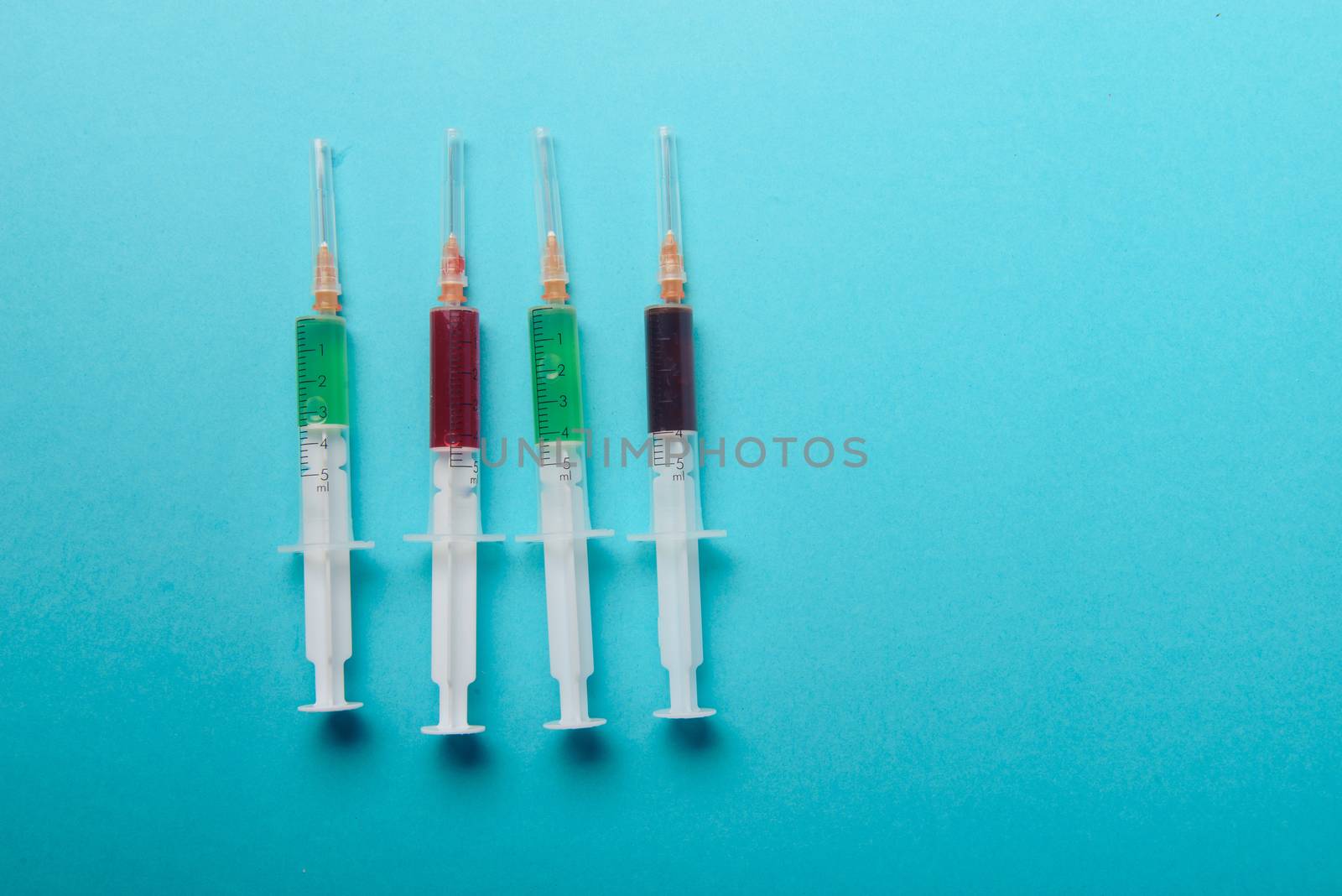 syringe on blue background. Injections. Food adittive