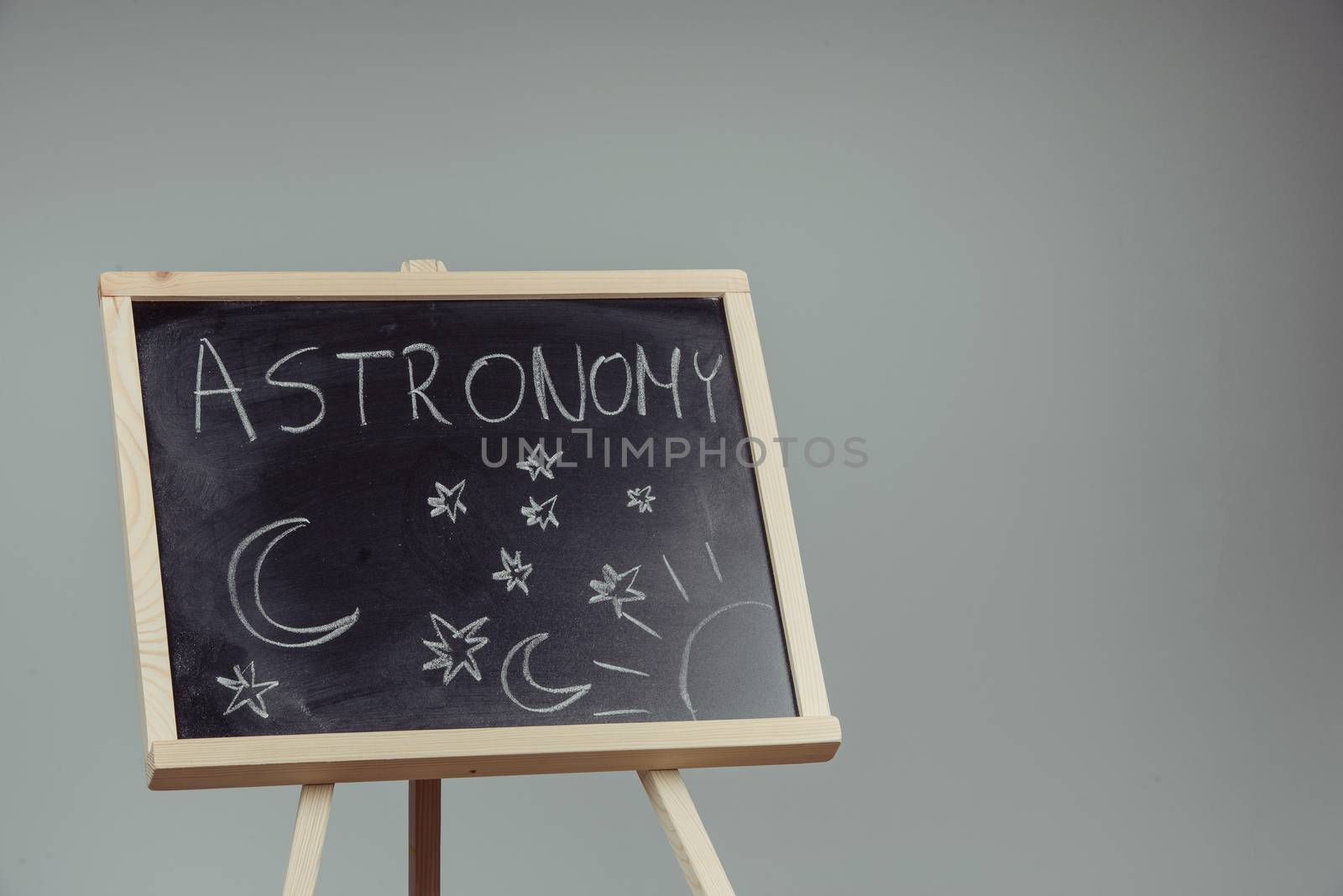 Woman draw on chalkboard astronomy subject. Gray background