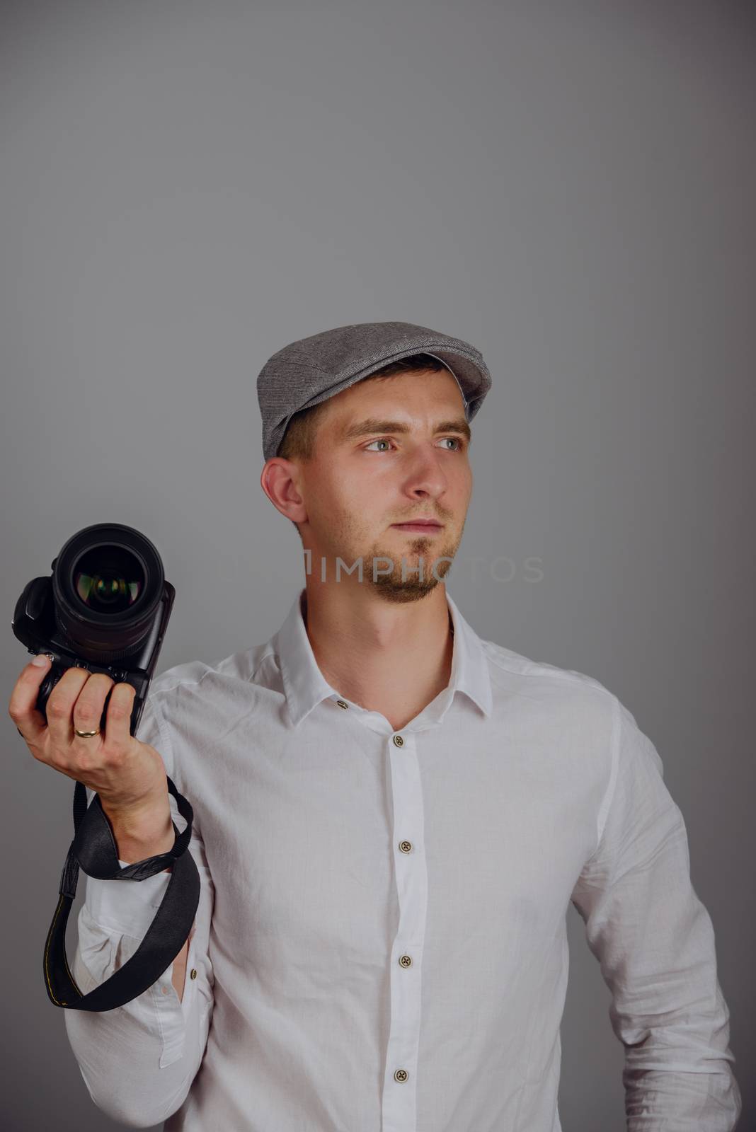 Young man using a professional camera in studio