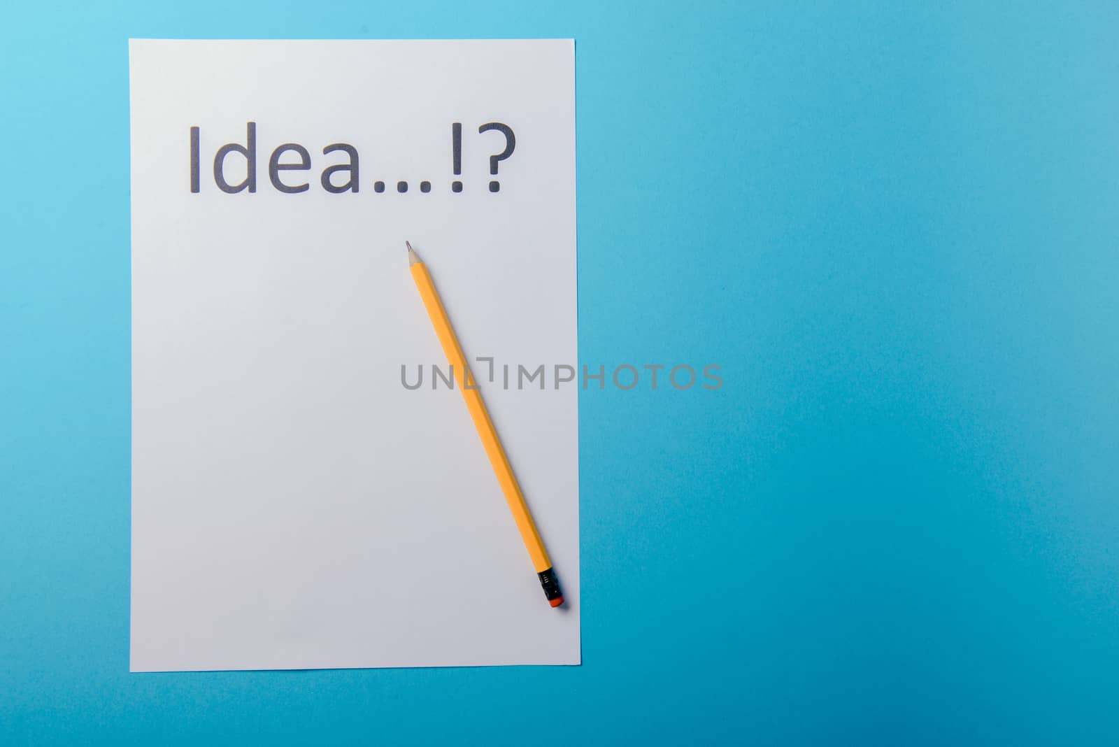 Idea word on white paper with pen. Blue background
