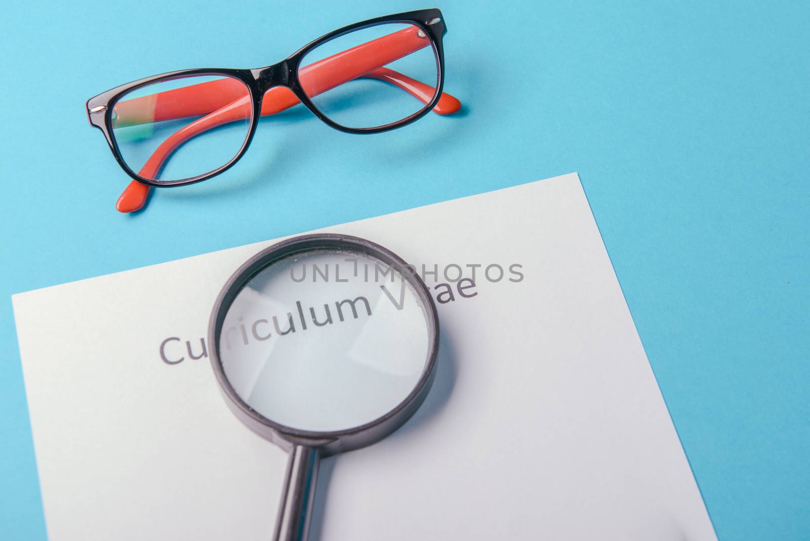 Curriculum vitae written on an blank white paper on blue background