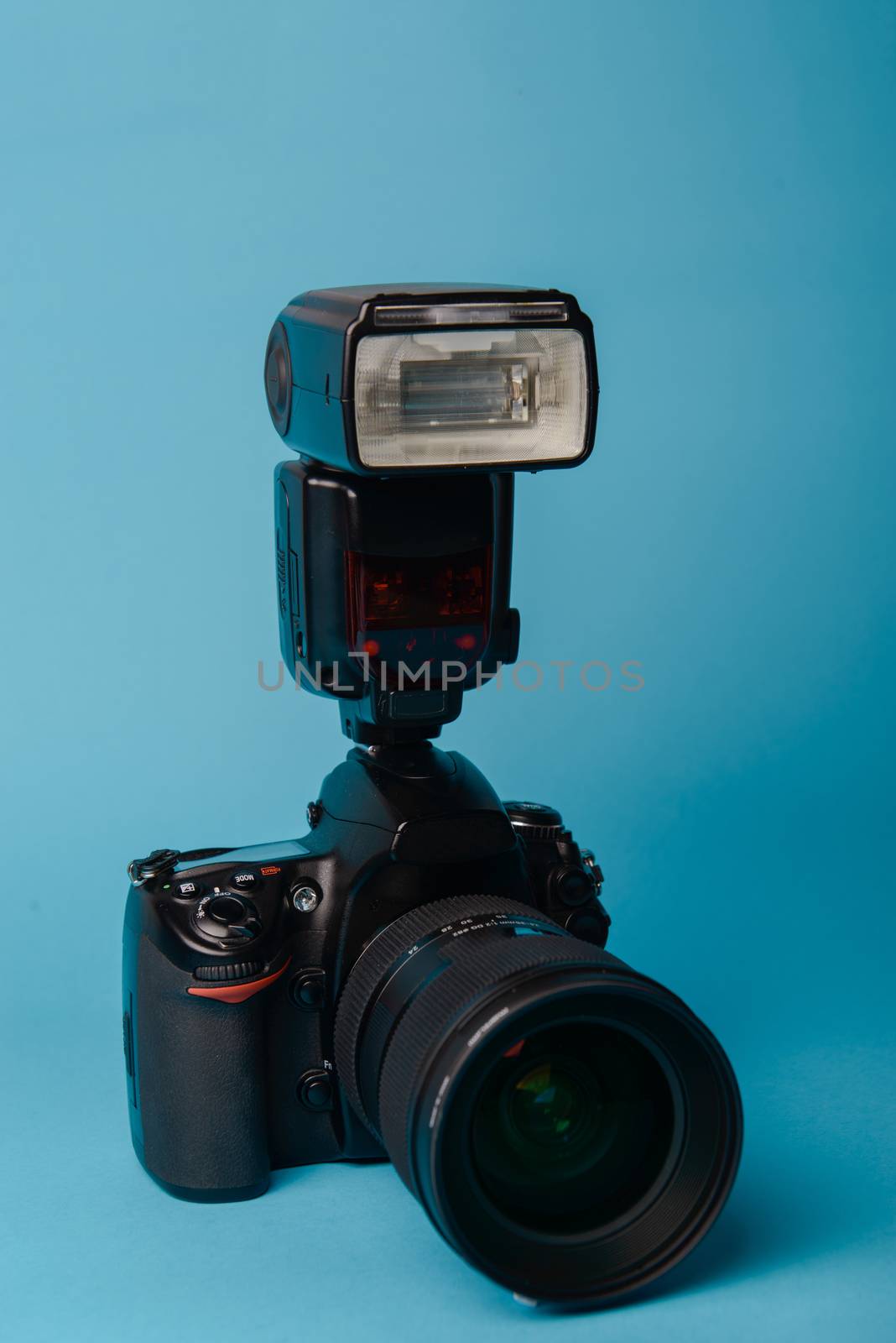 Professional modern DSLR camera against blue background