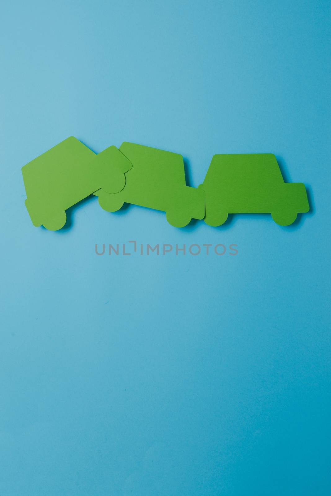 paper green cars figure. top view on blue background