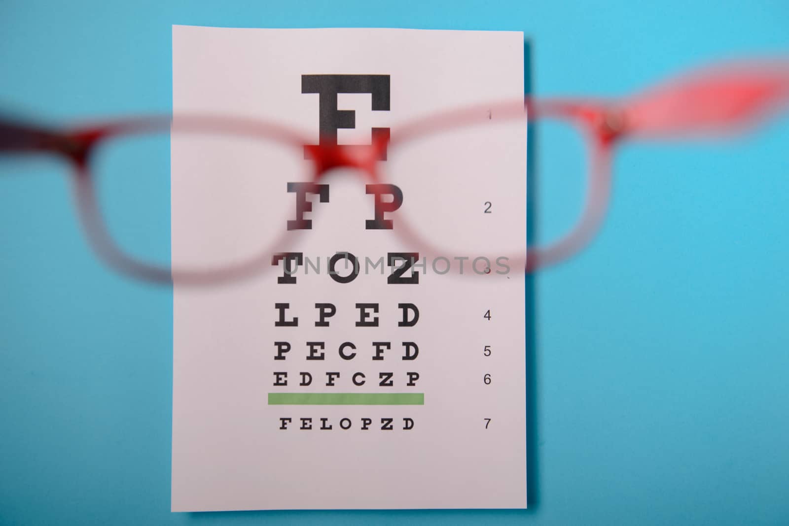 close up view of glasses lying on snellen test chart