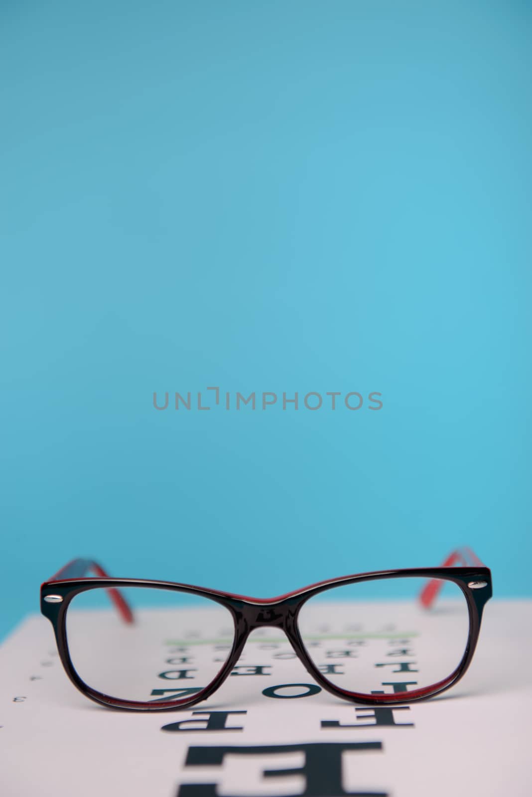 close up view of glasses lying on snellen test chart